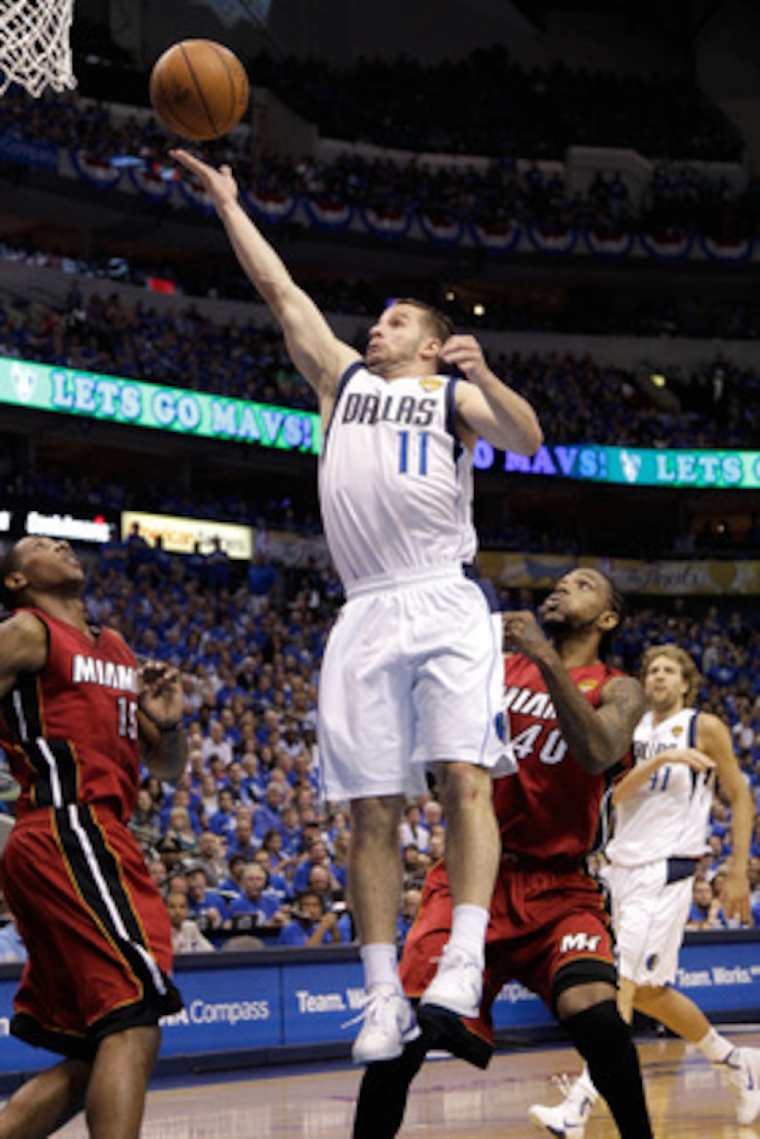 DALLAS, TX - JUNE 07:  Jose Juan Barea #11 of the Dallas Mavericks drives for a shot attempt against Mario Chalmers #15 and Udonis Haslem #40 of the Miami Heat in Game Four of the 2011 NBA Finals at American Airlines Center on June 7, 2011 in Dallas, Texa
