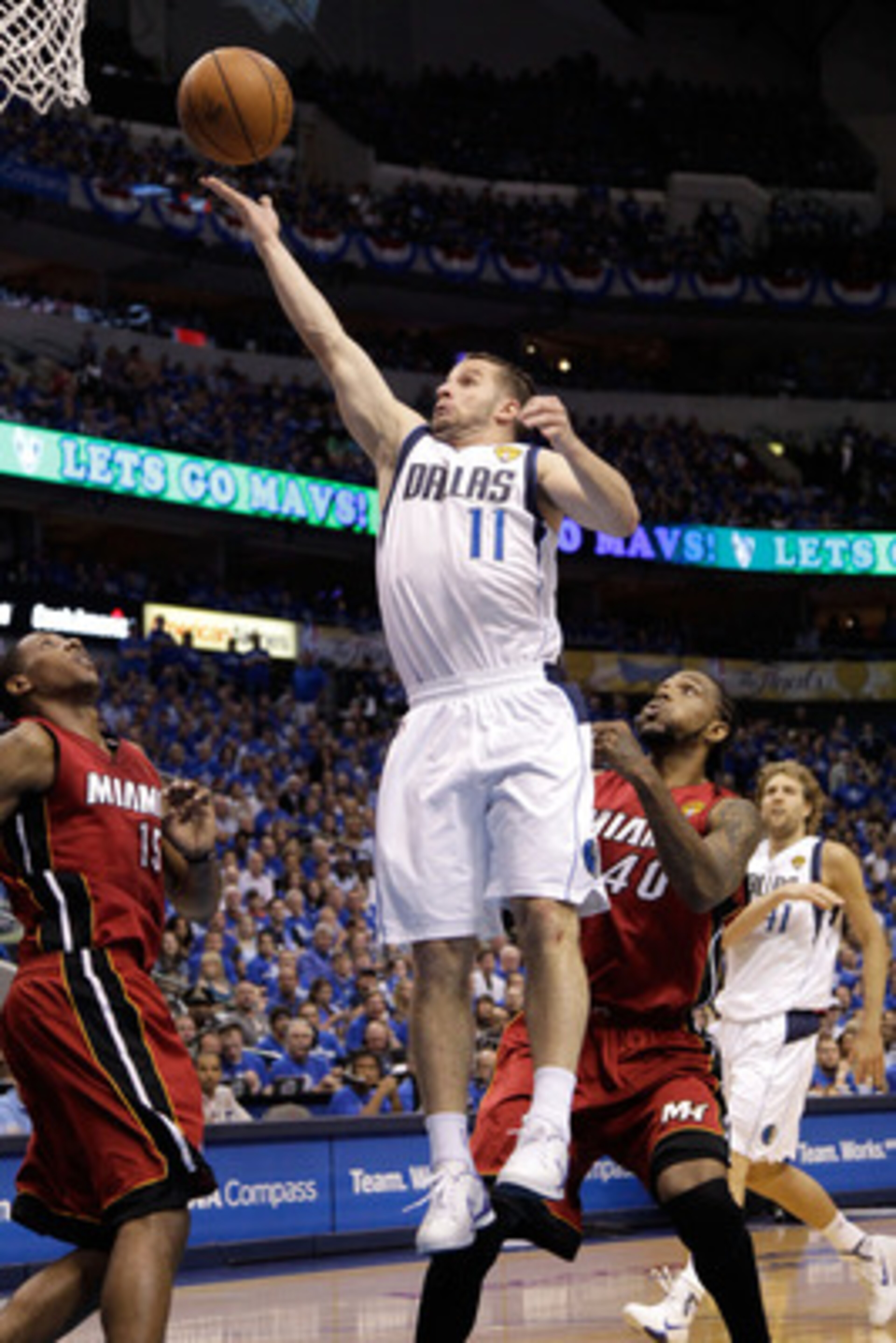 DALLAS, TX - JUNE 07:  Jose Juan Barea #11 of the Dallas Mavericks drives for a shot attempt against Mario Chalmers #15 and Udonis Haslem #40 of the Miami Heat in Game Four of the 2011 NBA Finals at American Airlines Center on June 7, 2011 in Dallas, Texa