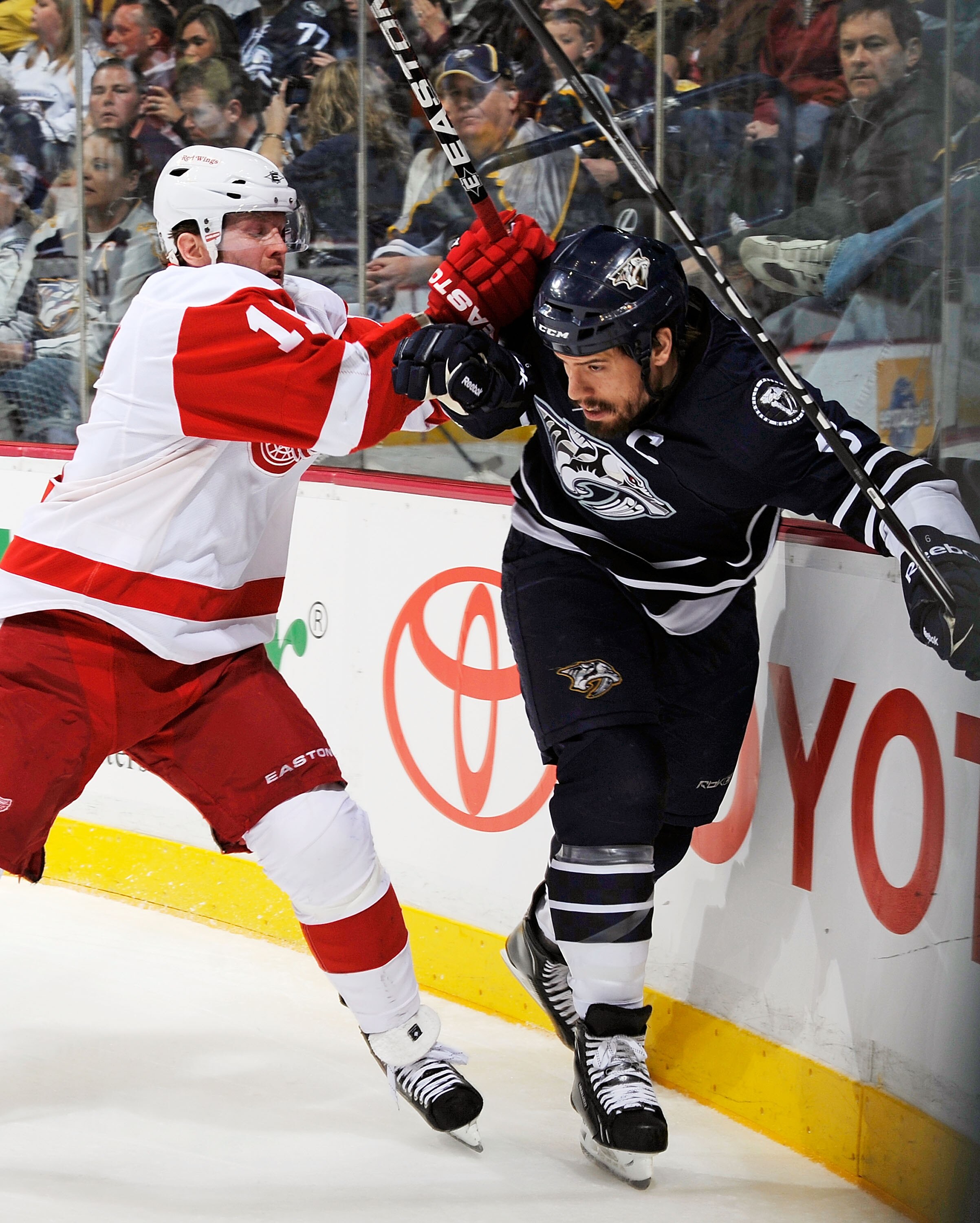 NASHVILLE, TN - MARCH 19:  Danny Cleary #11 of the Detroit Red Wings checks Shea Weber #6 of the Nashville Predators on March 19, 2011 at the Bridgestone Arena in Nashville, Tennessee.  (Photo by Frederick Breedon/Getty Images)