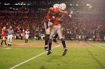 FORT LAUDERDALE, FL - SEPTEMBER 17: Defensive lineman Eric Moncur #94 and defensive back Vaughn Telemaque #7 of the Miami Hurricanes celebrate after sacking quarterback Josh Nesbitt #9 of the Georgia Tech Yellow Jackets at Land Shark Stadium on September 