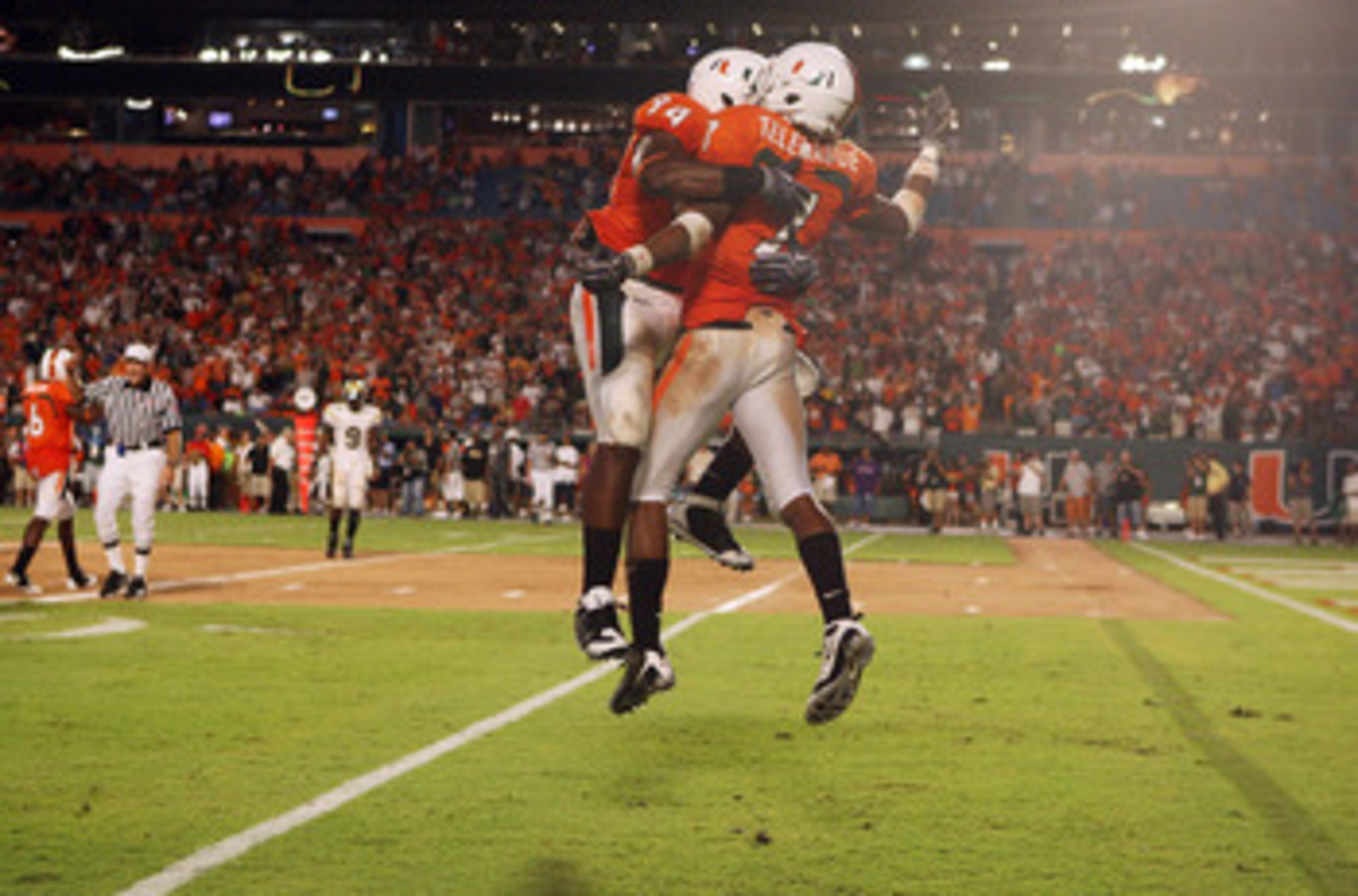 FORT LAUDERDALE, FL - SEPTEMBER 17: Defensive lineman Eric Moncur #94 and defensive back Vaughn Telemaque #7 of the Miami Hurricanes celebrate after sacking quarterback Josh Nesbitt #9 of the Georgia Tech Yellow Jackets at Land Shark Stadium on September 