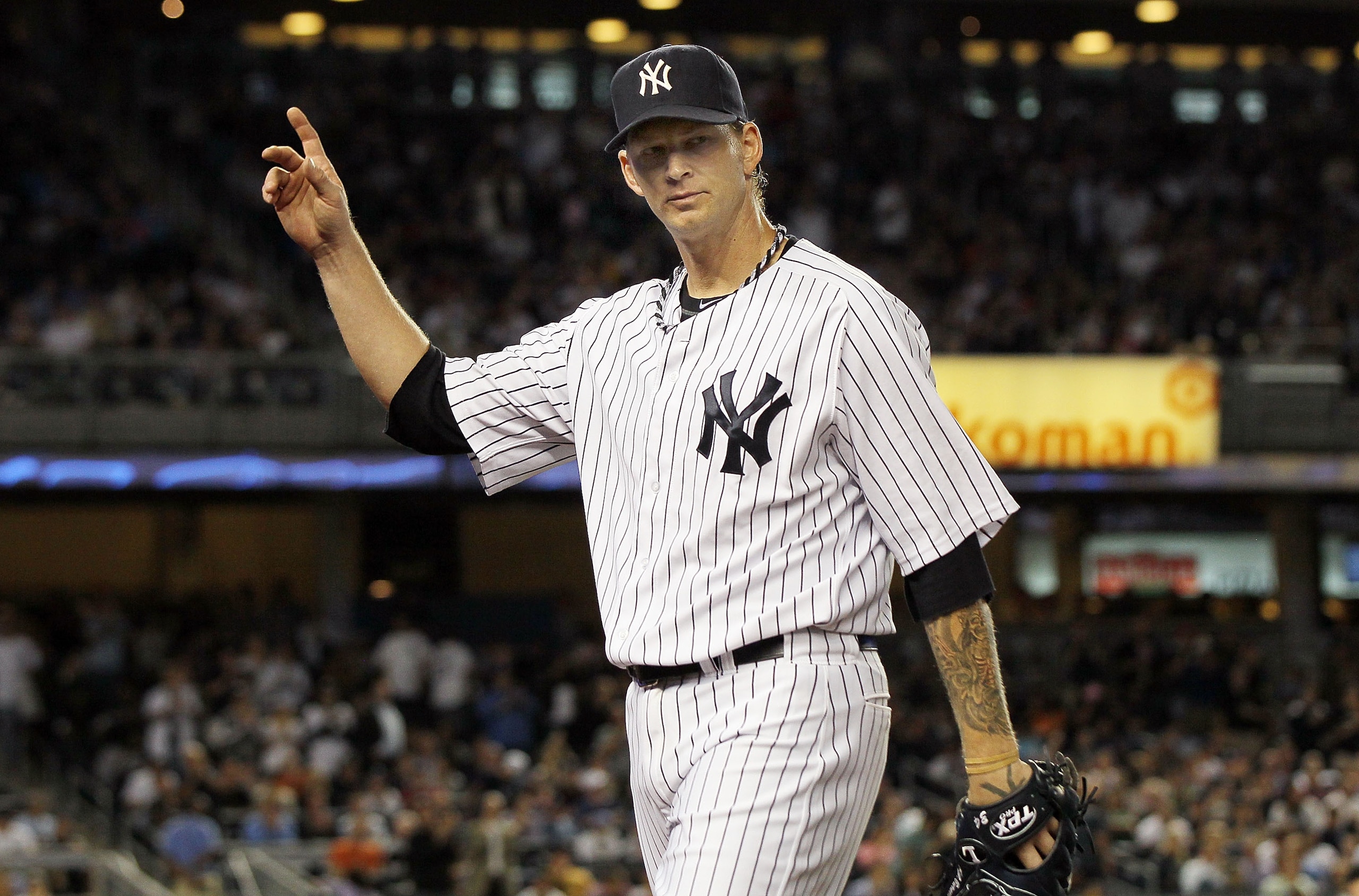 NEW YORK, NY - JUNE 13:  A.J. Burnett #34 of the New York Yankees salutes the crowd as he leaves the game in the eighth inning against the Cleveland Indians on June 13, 2011 at Yankee Stadium in the Bronx borough of New York City.  (Photo by Jim McIsaac/G