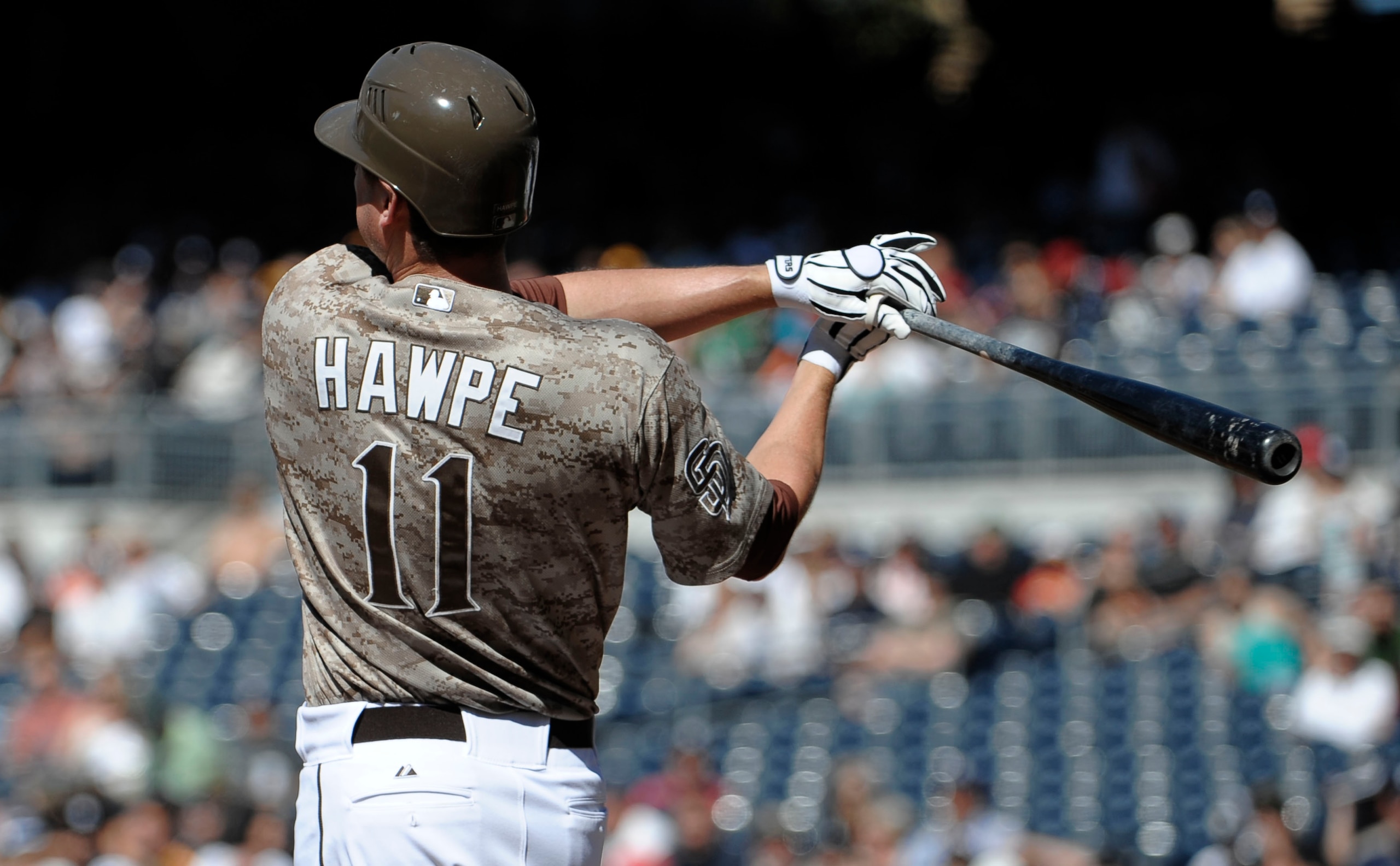 SAN DIEGO, CA - JUNE 5: Brad Hawpe #11 of the San Diego Padres hits an RBI single during the first inning of a baseball game against the Houston Astros at Petco Park on June 5, 2011 in San Diego, California.  (Photo by Denis Poroy/Getty Images)