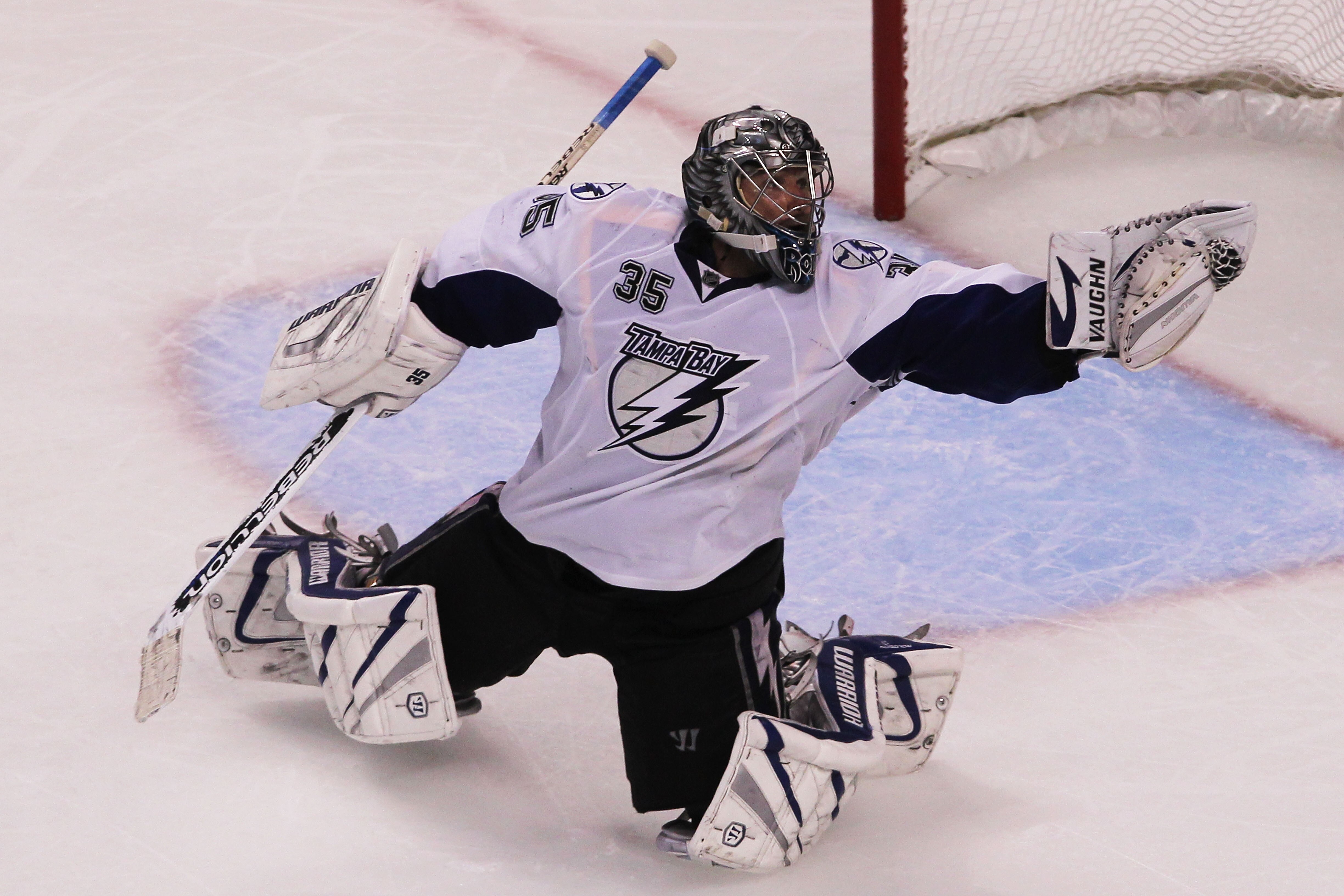 BOSTON, MA - MAY 27:  Dwayne Roloson #35 of the Tampa Bay Lightning reaches for a glove save in Game Seven of the Eastern Conference Finals during the 2011 NHL Stanley Cup Playoffs at TD Garden on May 27, 2011 in Boston, Massachusetts.  (Photo by Jim Roga