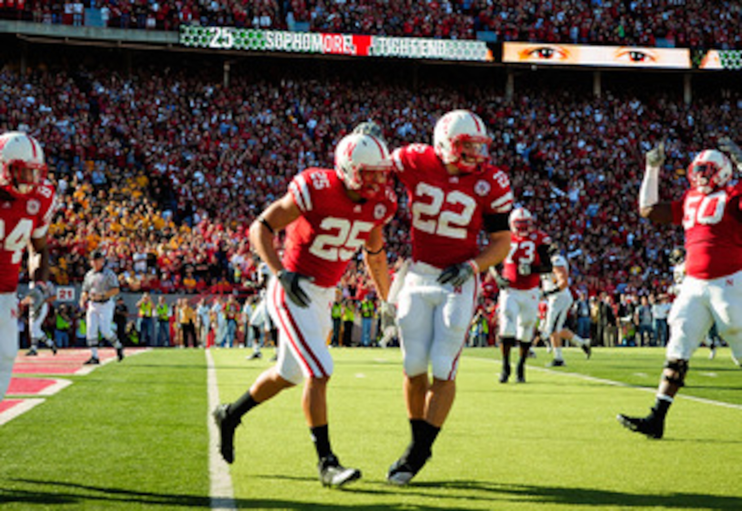LINCOLN, NE - OCTOBER 30:  Running back Rex Burkhead #22 and  tight end Kyler Reed #25 of the Nebraska Cornhuskers celebrate a touchdown during first half action of their game at Memorial Stadium on October 30, 2010 in Lincoln, Nebraska. Nebraska Defeated