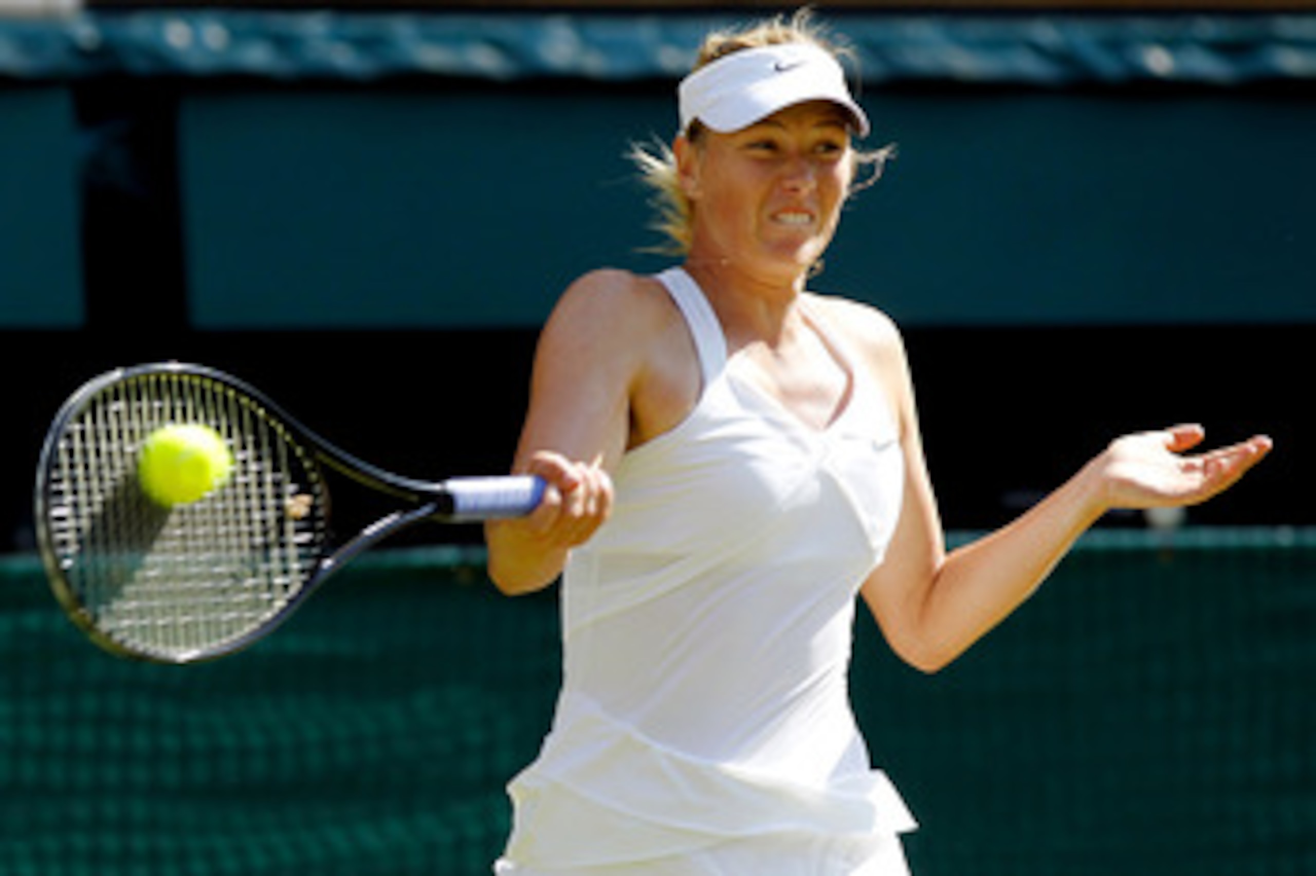 LONDON, ENGLAND - JUNE 28:  Maria Sharapova of Russia returns a shot during her match against Serena Williams of USA on Day Seven of the Wimbledon Lawn Tennis Championships at the All England Lawn Tennis and Croquet Club on June 28, 2010 in London, Englan