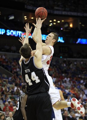 NEW ORLEANS, LA - MARCH 24:  Jon Leuer #30 of the Wisconsin Badgers goes up for a shot over Andrew Smith #44 of the Butler Bulldogs during the Southeast regional of the 2011 NCAA men's basketball tournament at New Orleans Arena on March 24, 2011 in New Or