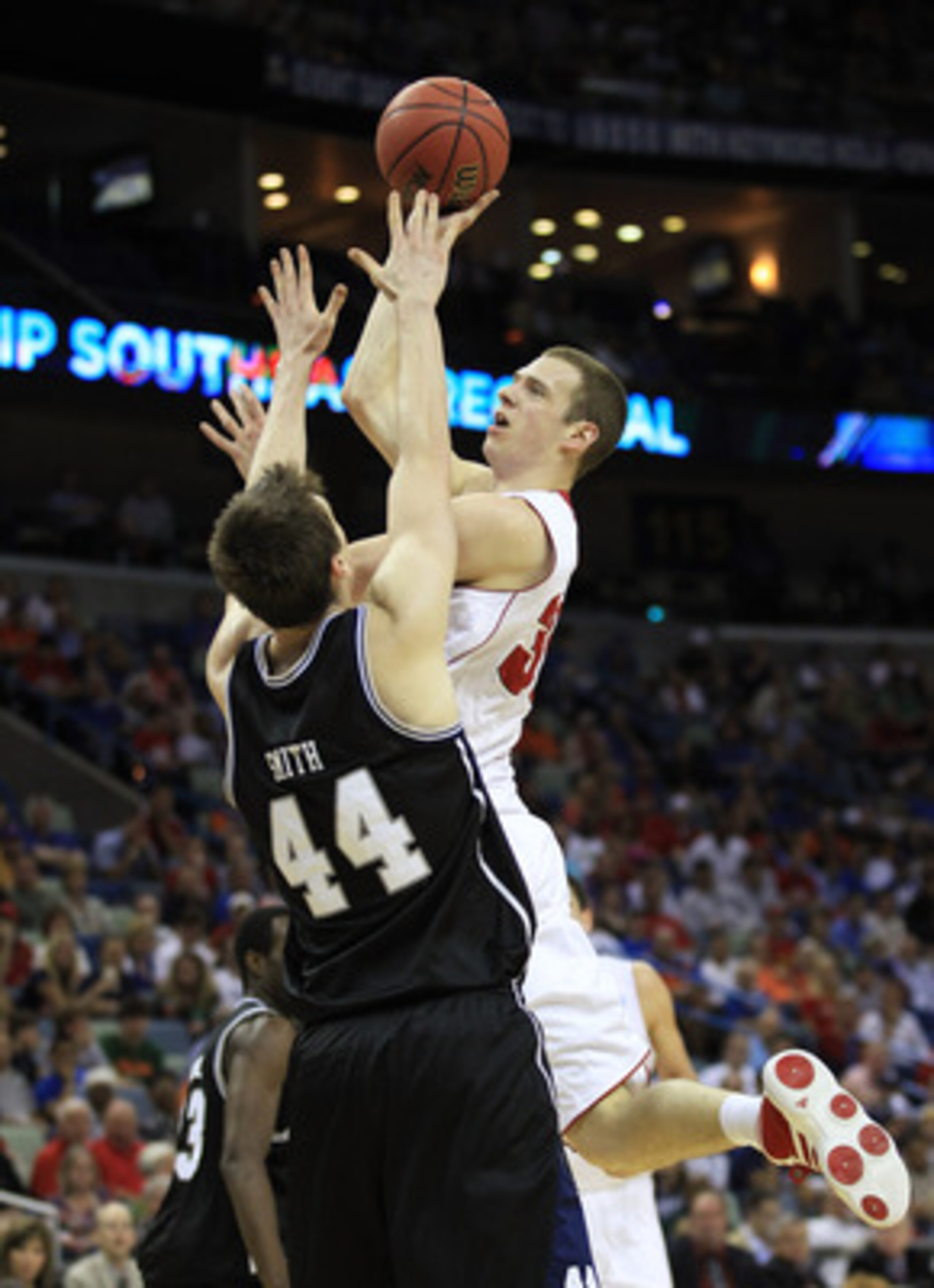NEW ORLEANS, LA - MARCH 24:  Jon Leuer #30 of the Wisconsin Badgers goes up for a shot over Andrew Smith #44 of the Butler Bulldogs during the Southeast regional of the 2011 NCAA men's basketball tournament at New Orleans Arena on March 24, 2011 in New Or