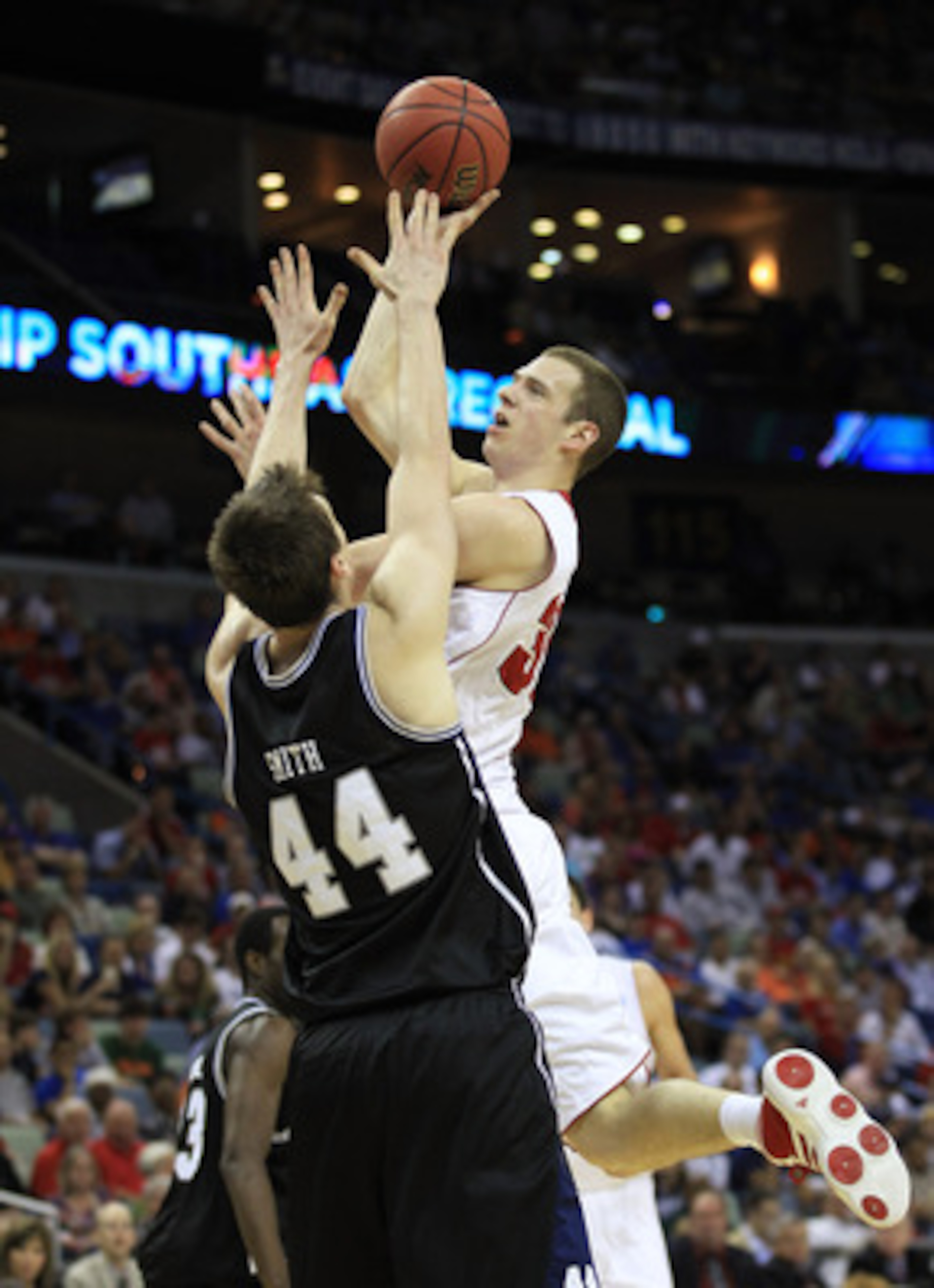 NEW ORLEANS, LA - MARCH 24:  Jon Leuer #30 of the Wisconsin Badgers goes up for a shot over Andrew Smith #44 of the Butler Bulldogs during the Southeast regional of the 2011 NCAA men's basketball tournament at New Orleans Arena on March 24, 2011 in New Or
