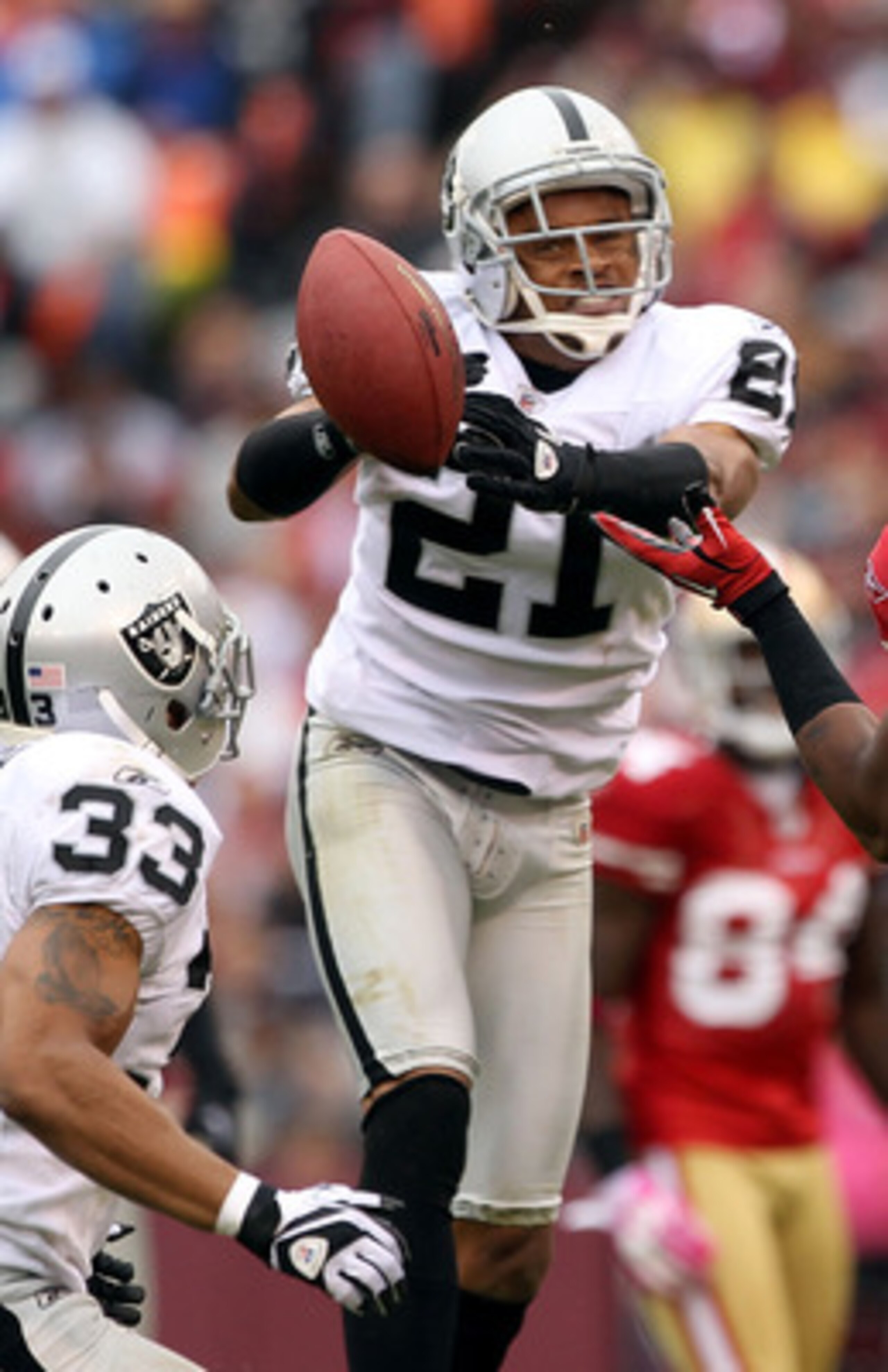 SAN FRANCISCO - OCTOBER 17: Nnamdi Asomugha #21 of the Oakland Raiders breaks up a pass intended for Michael Crabtree #15 of the San Francisco 49ers at Candlestick Park on October 17, 2010 in San Francisco, California. (Photo by Ezra Shaw/Getty Images) SAN FRANCISCO - OCTOBER 17: Nnamdi Asomugha #21 of the Oakland Raiders breaks up a pass intended for Michael Crabtree #15 of the San Francisco 49ers at Candlestick Park on October 17, 2010 in San Francisco, California. (Photo by Ezra Shaw/Getty Images)