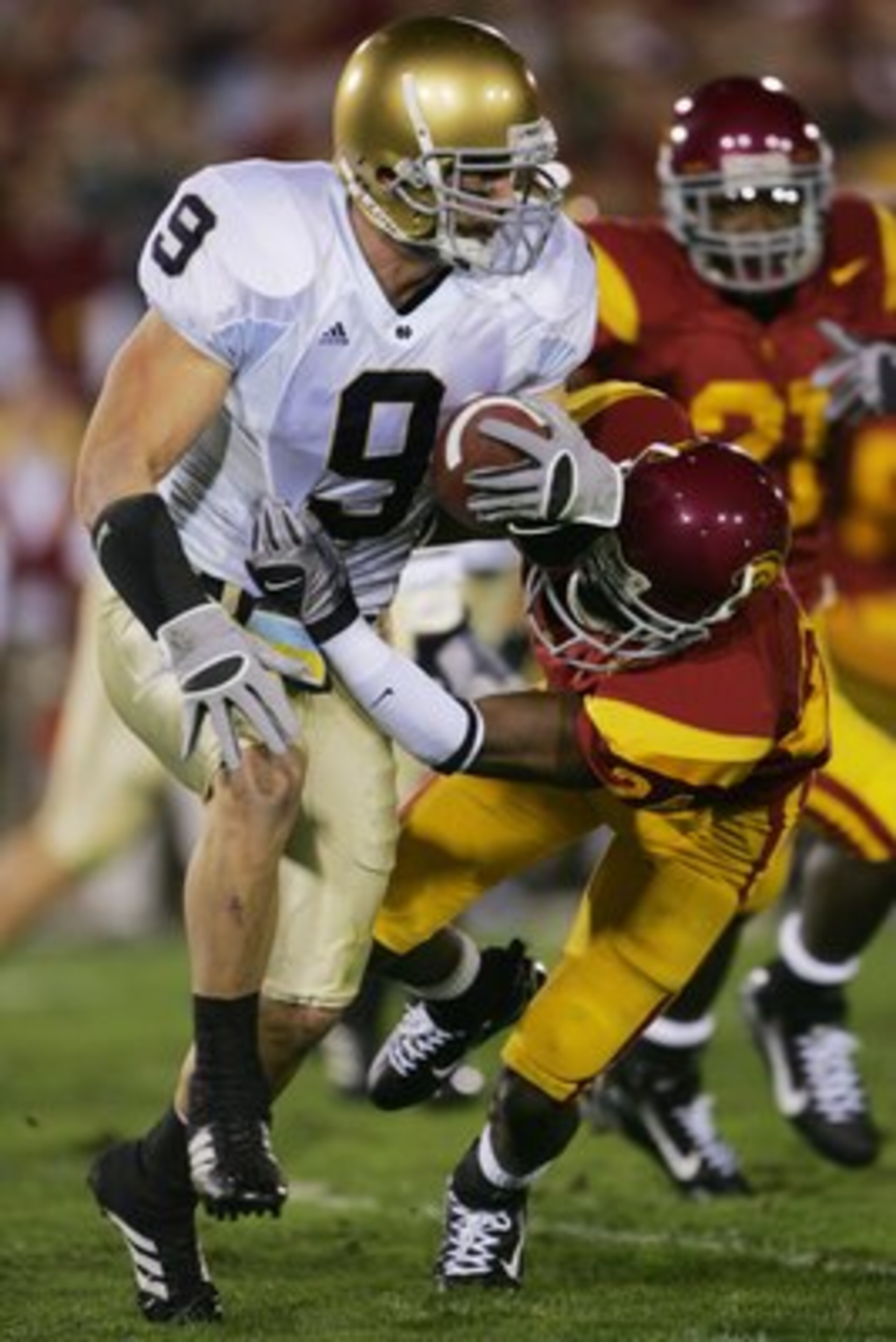 LOS ANGELES - NOVEMBER 25:  Kick returner Tom Zbikowski #9 of the Notre Dame Fighting Irish heads upfield against Shareece Wright #24 of the USC Trojans at the Los Angeles Memorial Coliseum on November 25, 2006 in Los Angeles, California. USC won 44-24. (