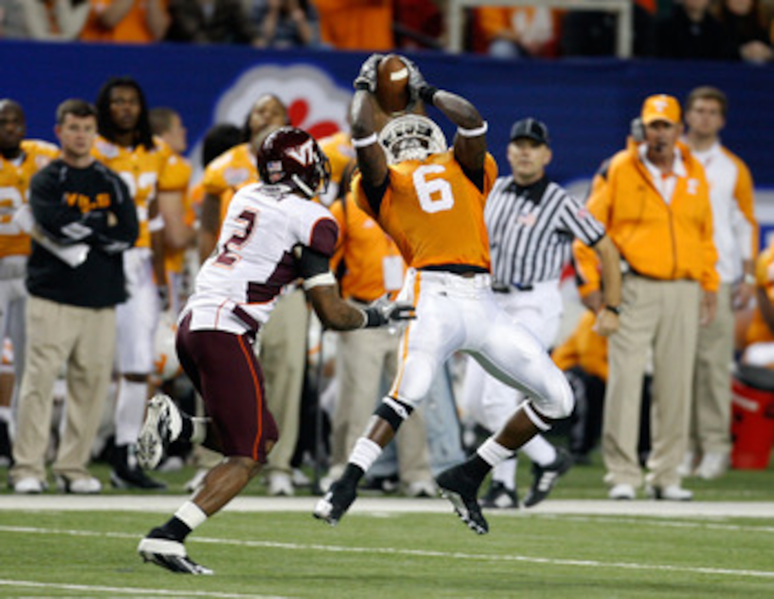 ATLANTA - DECEMBER 31:  Wide receiver Denarius Moore #6 of the Tennessee Volunteers hauls in a second quarter pass while defensive back Devon Morgan #2 of the Virginia Tech Hokies tries to cover him during the Chick-Fil-A Bowl at the Georgia Dome on Decem