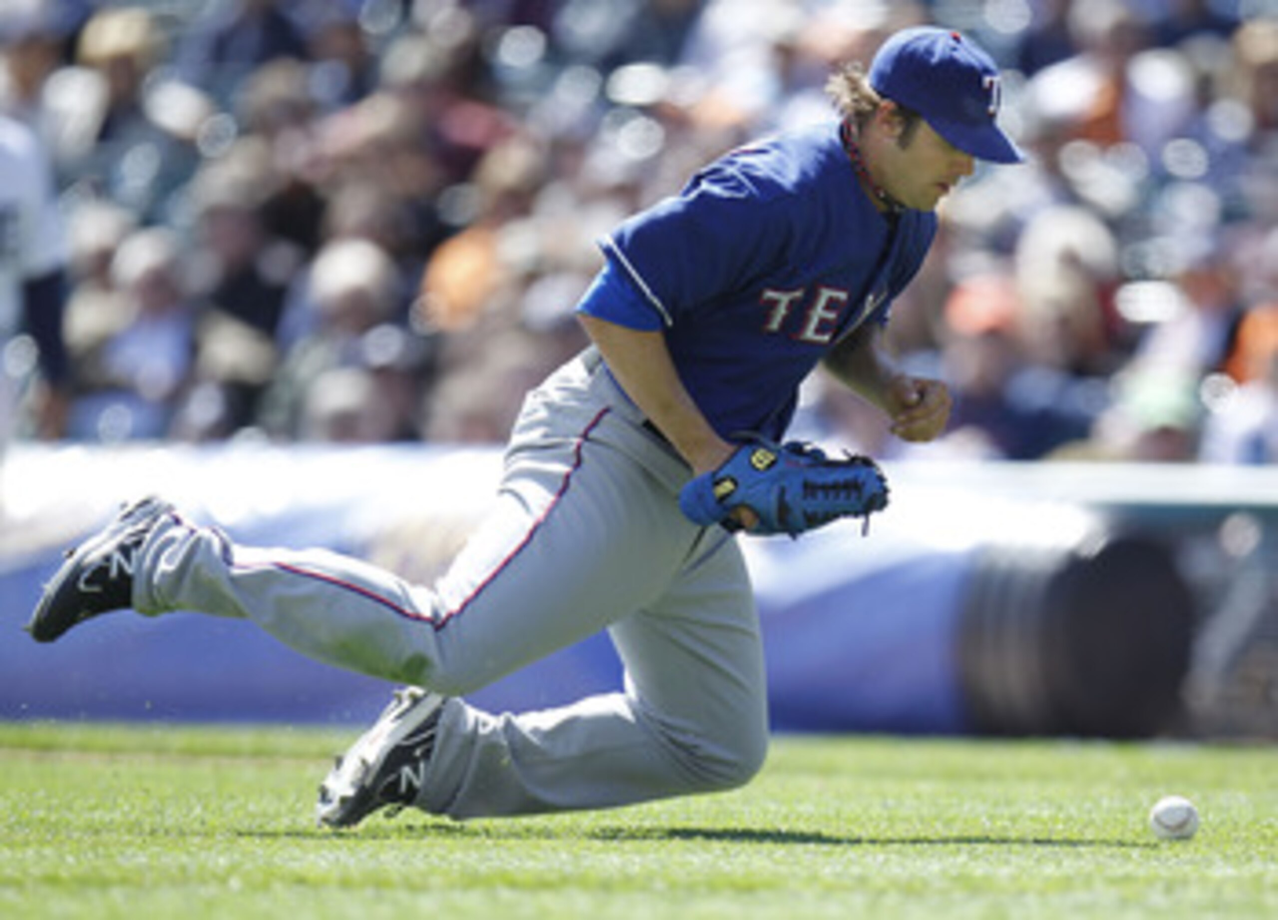 DETROIT, MI - APRIL 12: C.J. Wilson #36 of the Texas Rangers can't handle a ground ball hit to him while playing the Detroit Tigers at Comerica Park on April 12, 2011 in Detroit, Michigan. Detroit won the game 5-4. (Photo by Gregory Shamus/Getty Images) DETROIT, MI - APRIL 12: C.J. Wilson #36 of the Texas Rangers can't handle a ground ball hit to him while playing the Detroit Tigers at Comerica Park on April 12, 2011 in Detroit, Michigan. Detroit won the game 5-4. (Photo by Gregory Shamus/Getty Images)