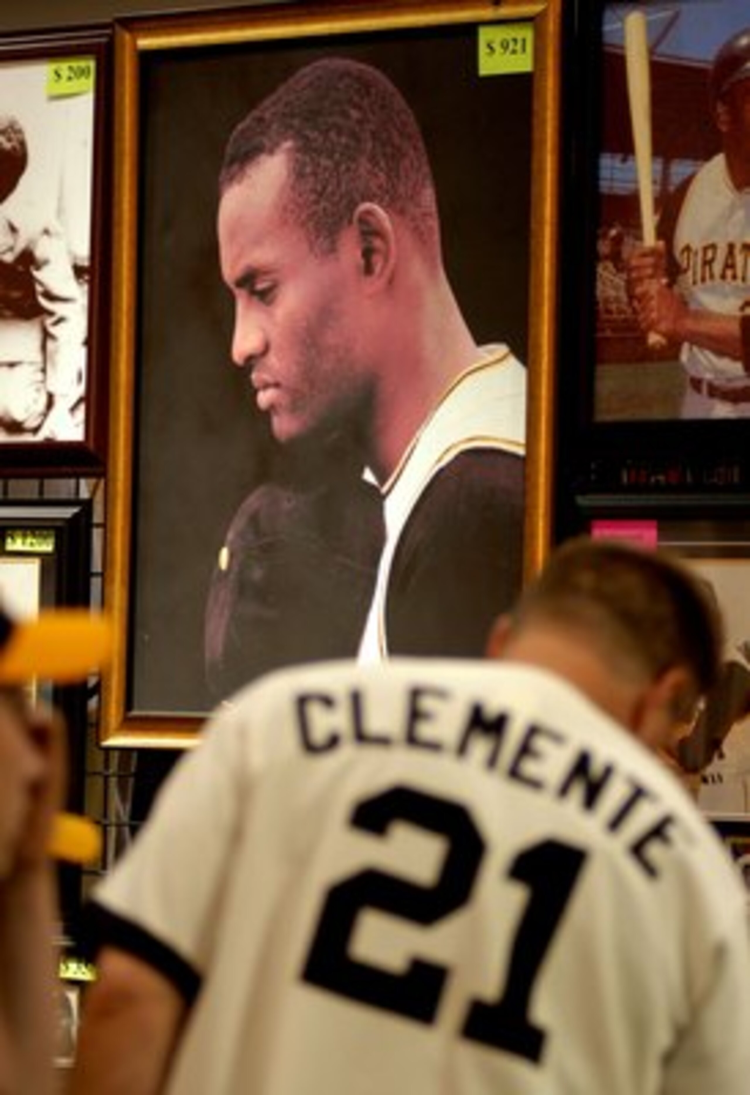 PITTSBURGH - JULY 7: Fans look over Roberto Clemente memorabilia during opening day of Fan Fest for the Major League Baseball 2006 All-Star game at the David L. Lawrence Convention Center July 7, 2006 in Pittsburgh, Pennsylvania. (Photo by Paul Hawthorne/ PITTSBURGH - JULY 7: Fans look over Roberto Clemente memorabilia during opening day of Fan Fest for the Major League Baseball 2006 All-Star game at the David L. Lawrence Convention Center July 7, 2006 in Pittsburgh, Pennsylvania. (Photo by Paul Hawthorne/