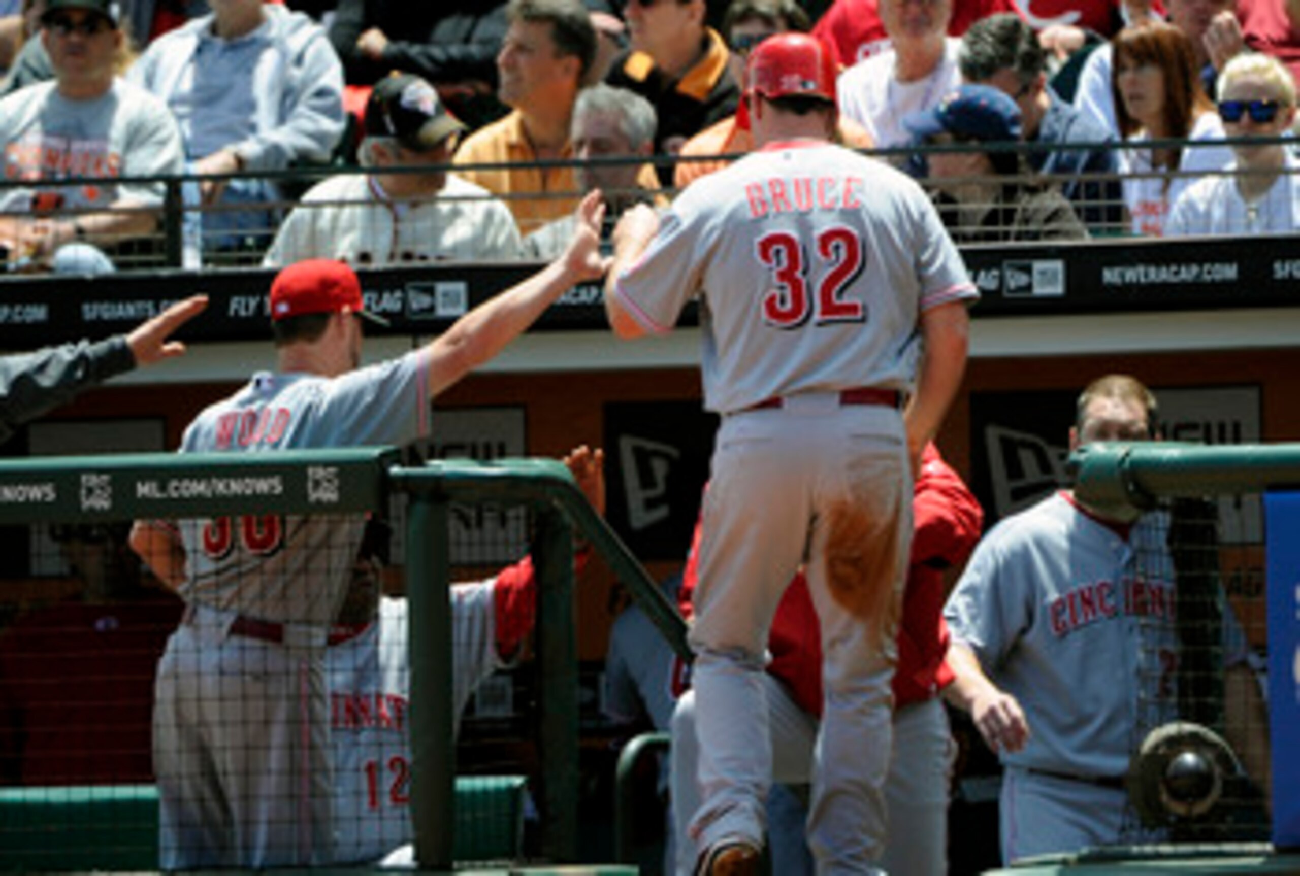 SAN FRANCISCO, CA - JUNE 11: Jay Bruce #32 of the Cincinnati Reds returns to the dugout after scoring and get a high five from teammate Travis Wood #30 against the San Francisco Giants during a MLB baseball game June 11, 2011 at AT&T Park in San Francisco SAN FRANCISCO, CA - JUNE 11: Jay Bruce #32 of the Cincinnati Reds returns to the dugout after scoring and get a high five from teammate Travis Wood #30 against the San Francisco Giants during a MLB baseball game June 11, 2011 at AT&T Park in San Francisco