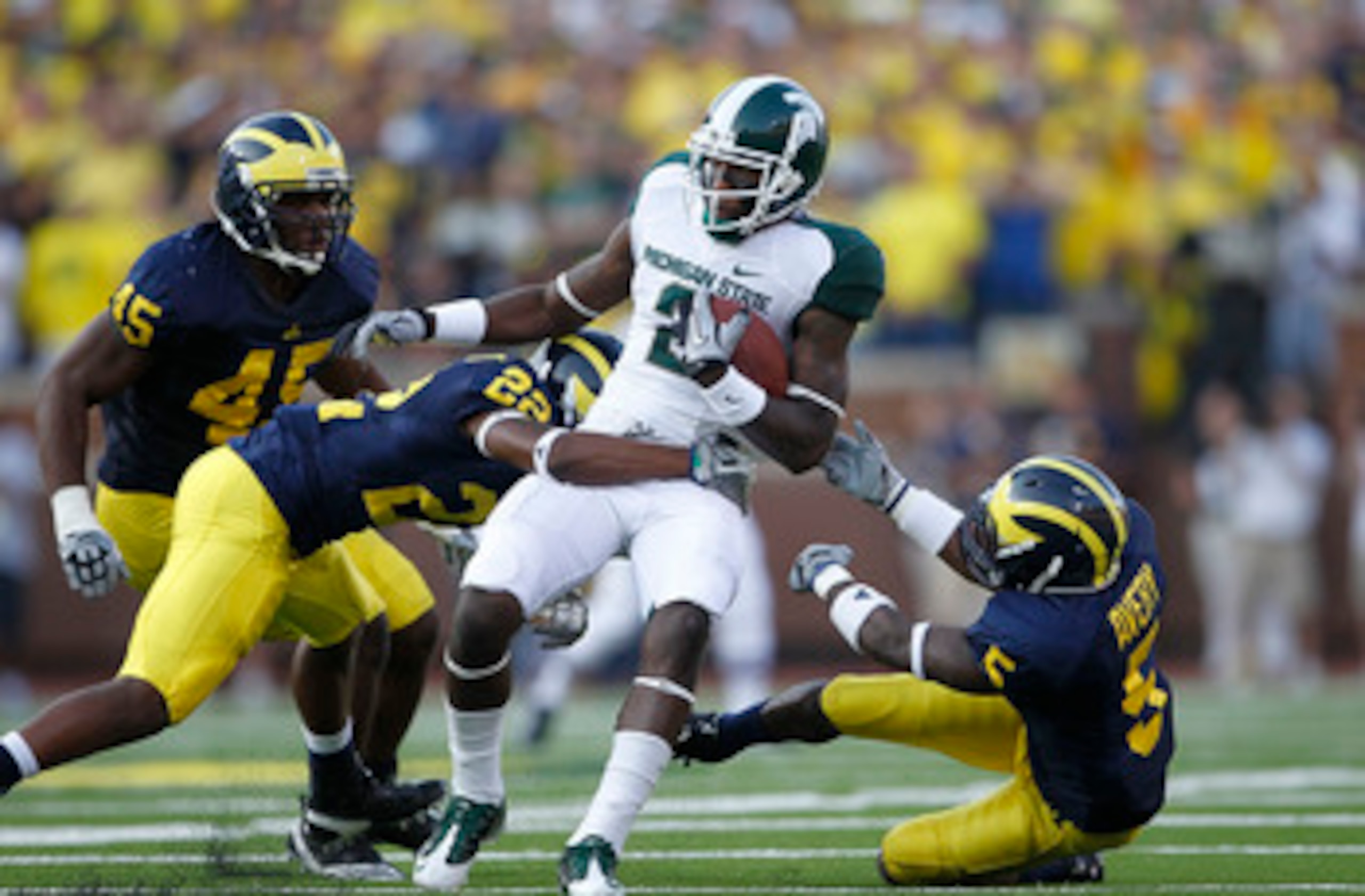ANN ARBOR, MI - OCTOBER 09:  Mark Dell #2 of the Michigan State Spartans catches a 41 yard pass during the second quarter as Terrence Talbott #22 and Courtney Avery #5 of the Michigan Wolverines make the stop during the game on October 9, 2010 at Michigan