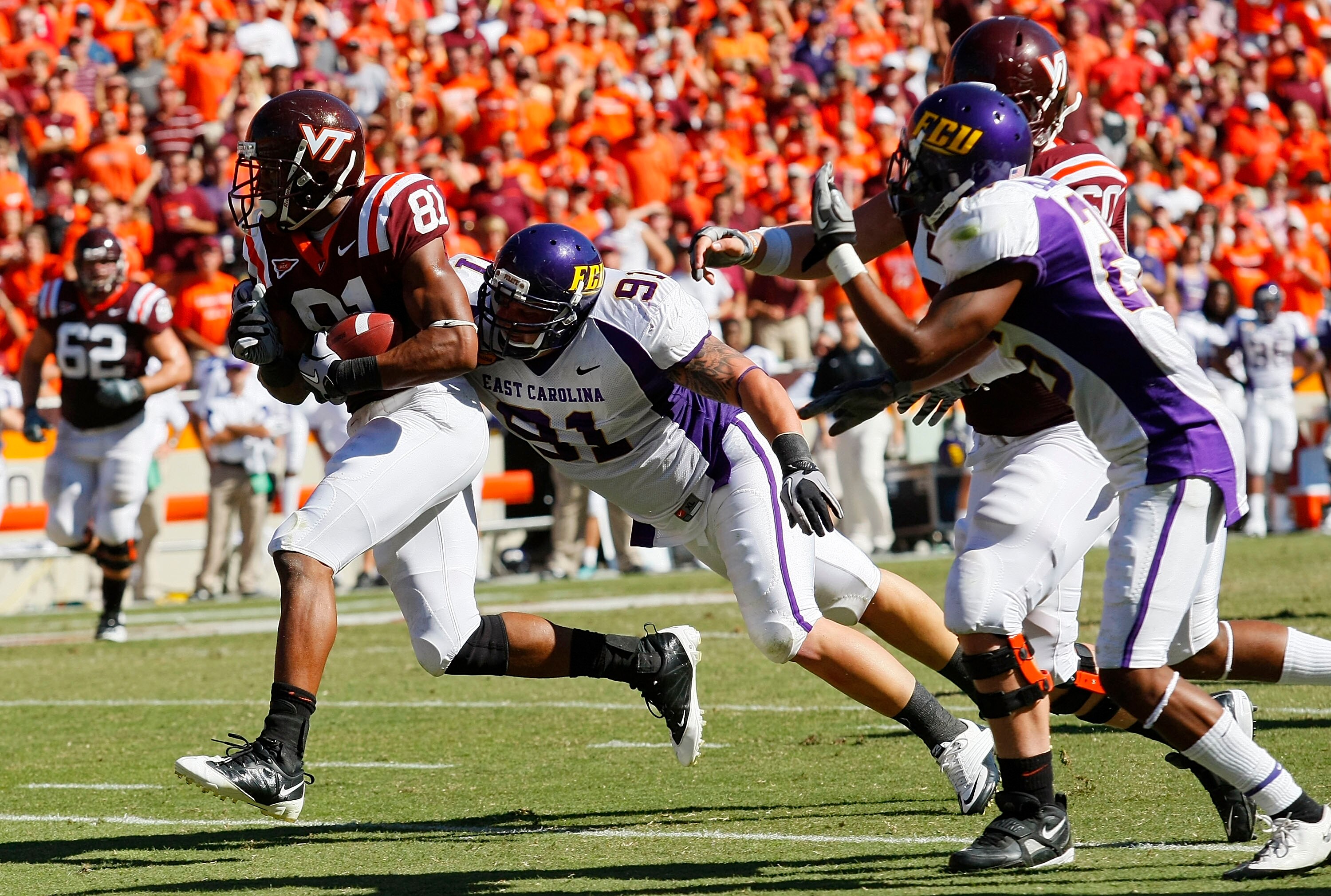 BLACKSBURG, VA - SEPTEMBER 18: Wide receiver Jarrett Boykin #81 of the Virginia Tech Hokies runs with the ball as defensive tackle Josh Smith #91 of the East Carolina Pirates tries to make the tackle at Lane Stadium on September 18, 2010 in Blacksburg, Vi