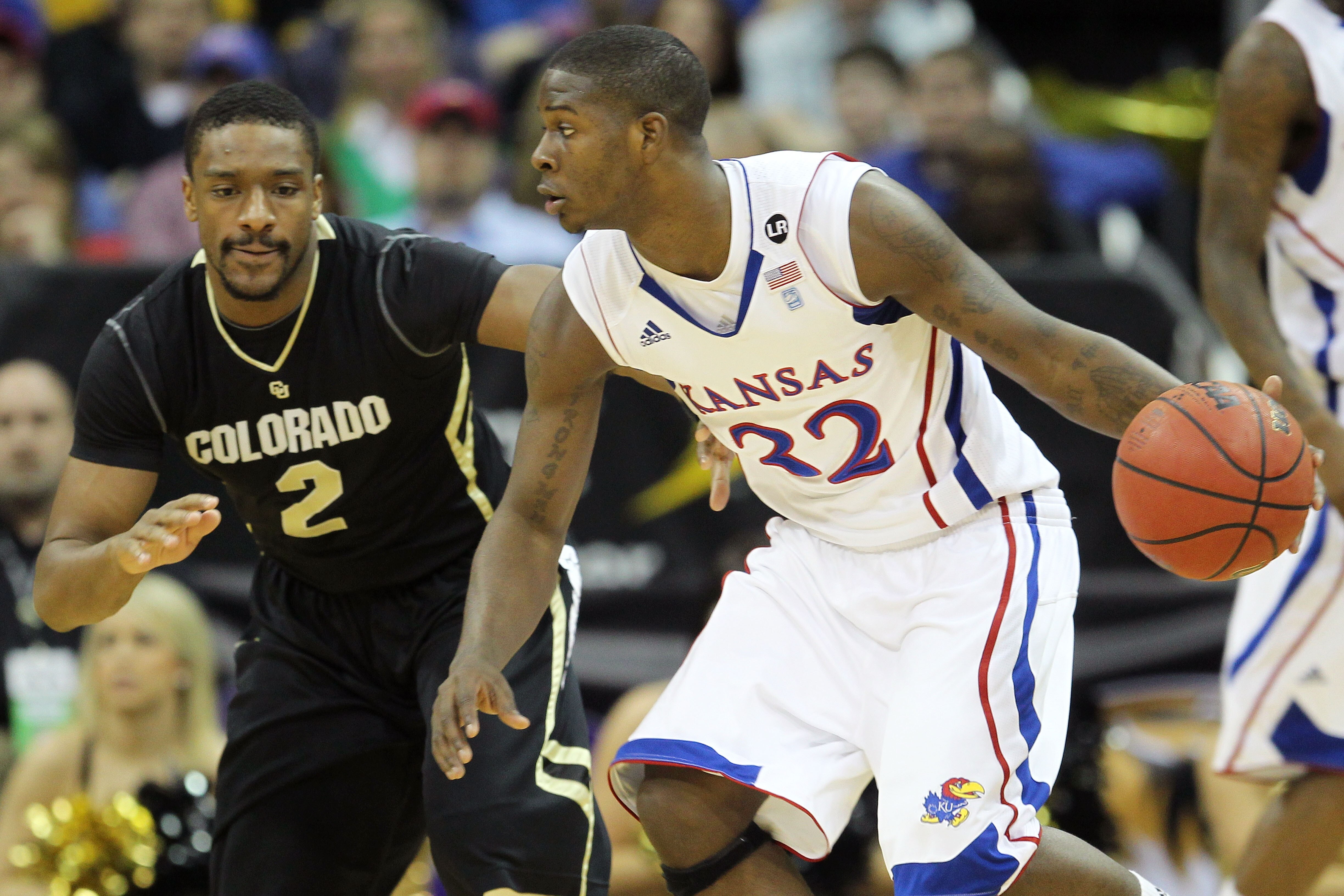 KANSAS CITY, MO - MARCH 11:  Josh Selby #32 of the Kansas Jayhawks drives with the ball against Shannon Sharpe #2 of the Colorado Buffaloes during their semifinal game in the 2011 Phillips 66 Big 12 Men's Basketball Tournament at Sprint Center on March 11
