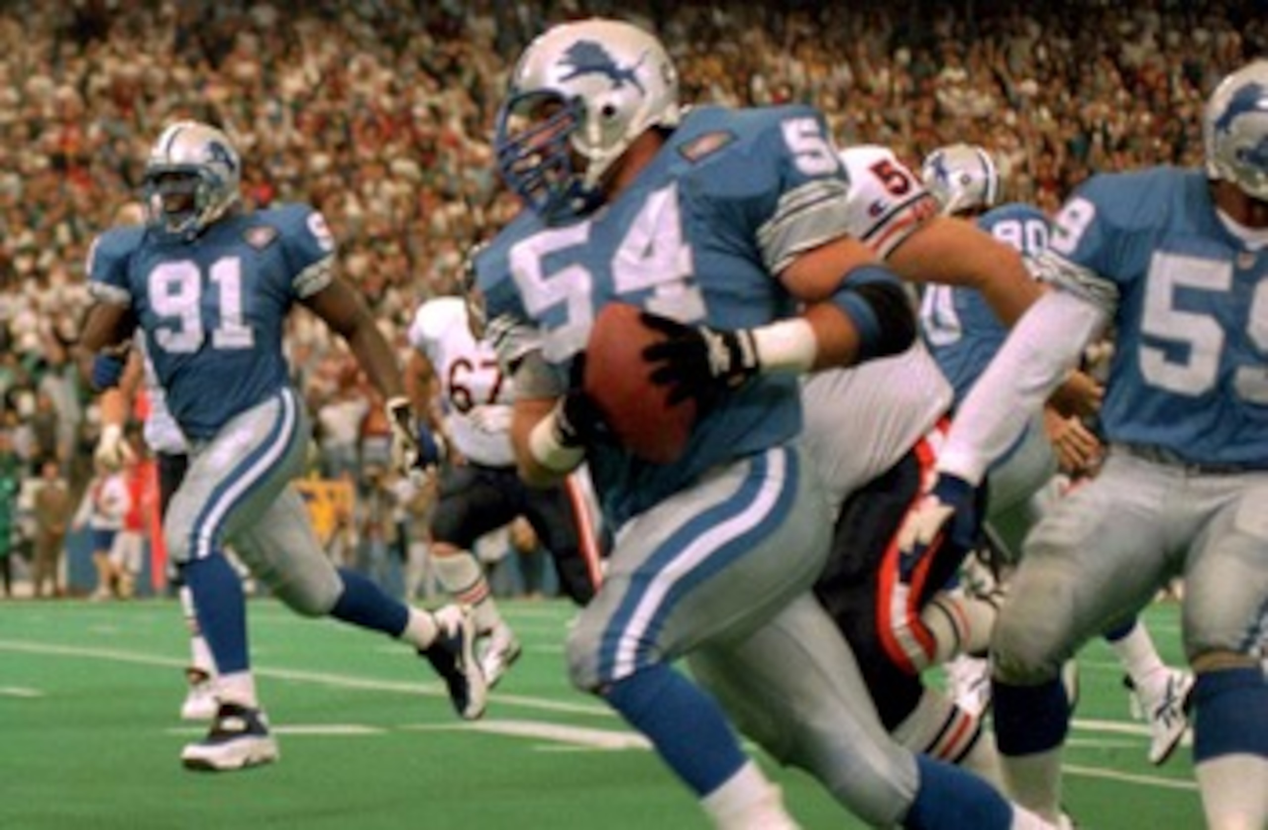 23 OCT 1994:  DETROIT LION LINEBACKER CHRIS SPIELMAN HEADS FOR THE ENDZONE AFTER STRIPPING THE BALL FROM THE HANDS OF CHICAGO BEAR CHRIS GEDNEY DURING THE FIRST HALF OF THE LION''S 21-16 VICTORY OVER THE BEARS. Mandatory Credit: Todd Rosenberg/ALLSPORT