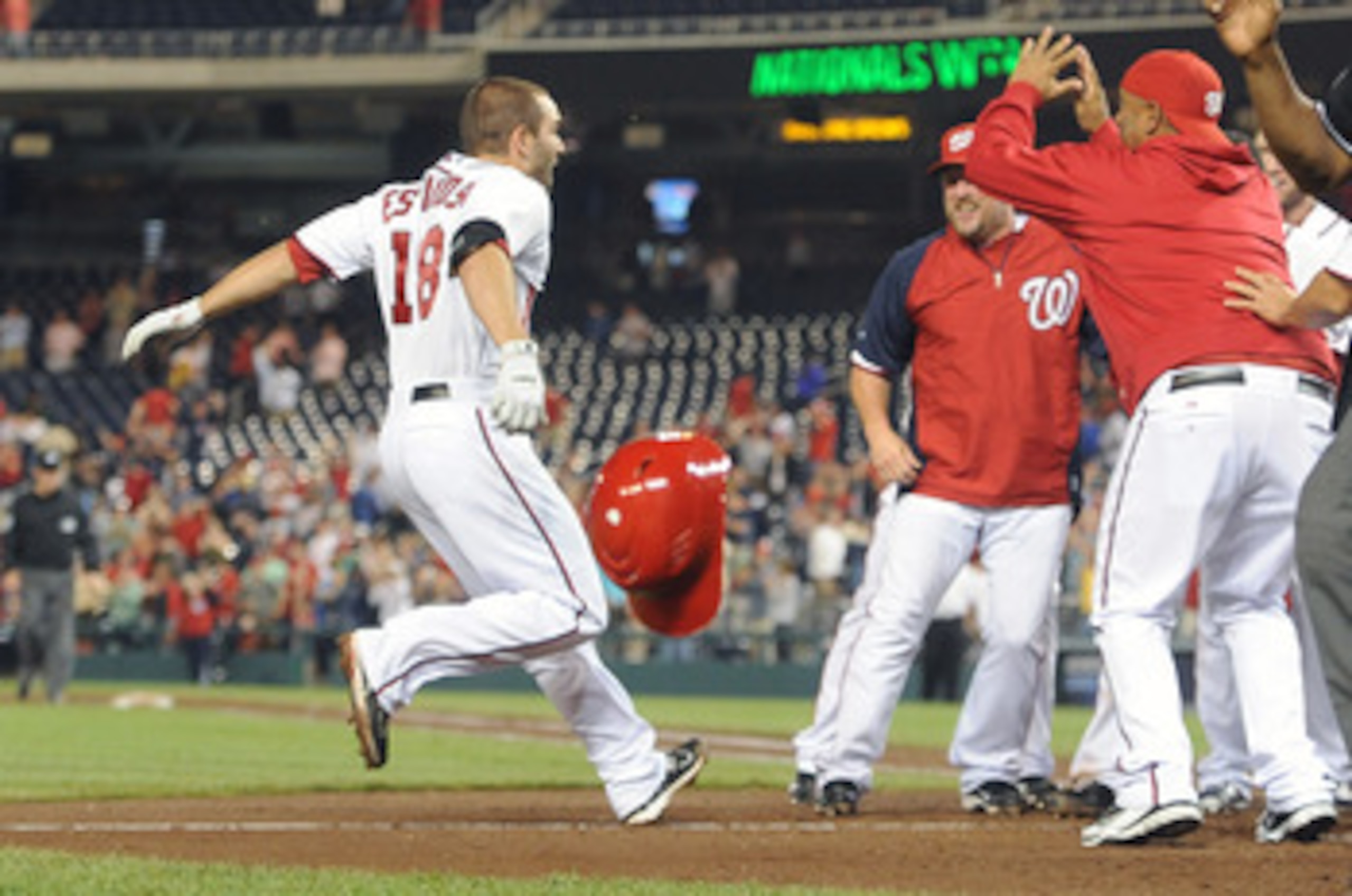 WASHINGTON, DC - JUNE 16:  Danny Espinosa #18 of the Washington Nationals celebrates with teammates after hitting the game winning three run home run in the tenth inning against the St. Louis Cardinals at Nationals Park on June 16, 2011 in Washington, DC.