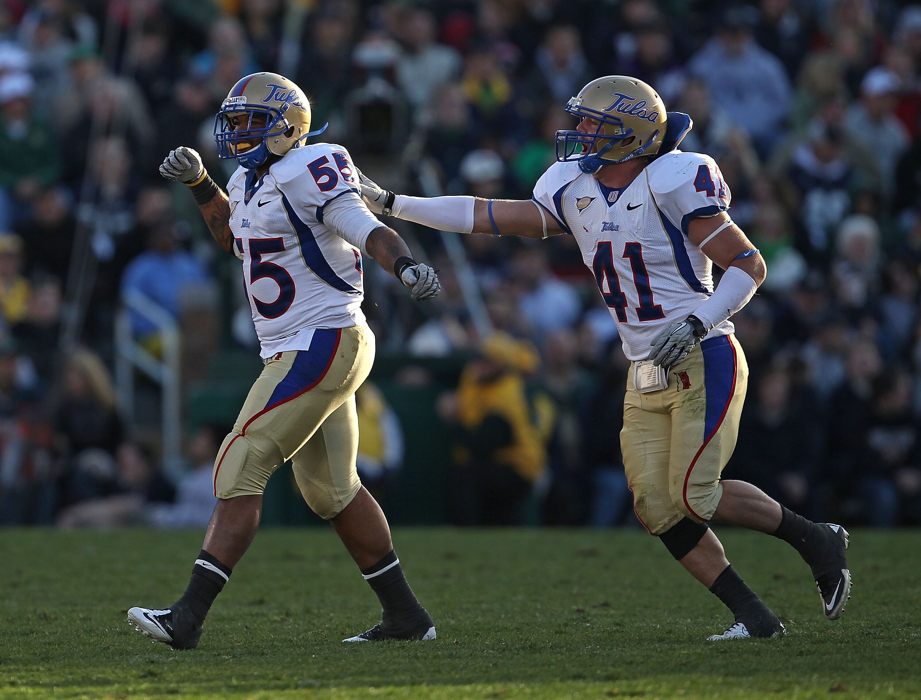 SOUTH BEND, IN - OCTOBER 30: Shawn Jackson #55 and Cody Wilson #41 of the Tulsa Golden Hurricane celebrate a sack against the Notre Dame Fighting Irish at Notre Dame Stadium on October 30, 2010 in South Bend, Indiana. Tulsa defeated Notre Dame 28-27. (Pho