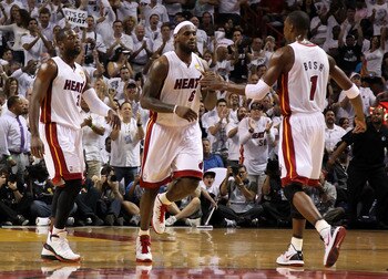 MIAMI, FL - JUNE 12:  (L-R) Dwyane Wade #3, LeBron James #6 and Chris Bosh #1 of the Miami Heat react on court against the Dallas Mavericks in Game Six of the 2011 NBA Finals at American Airlines Arena on June 12, 2011 in Miami, Florida. NOTE TO USER: Use