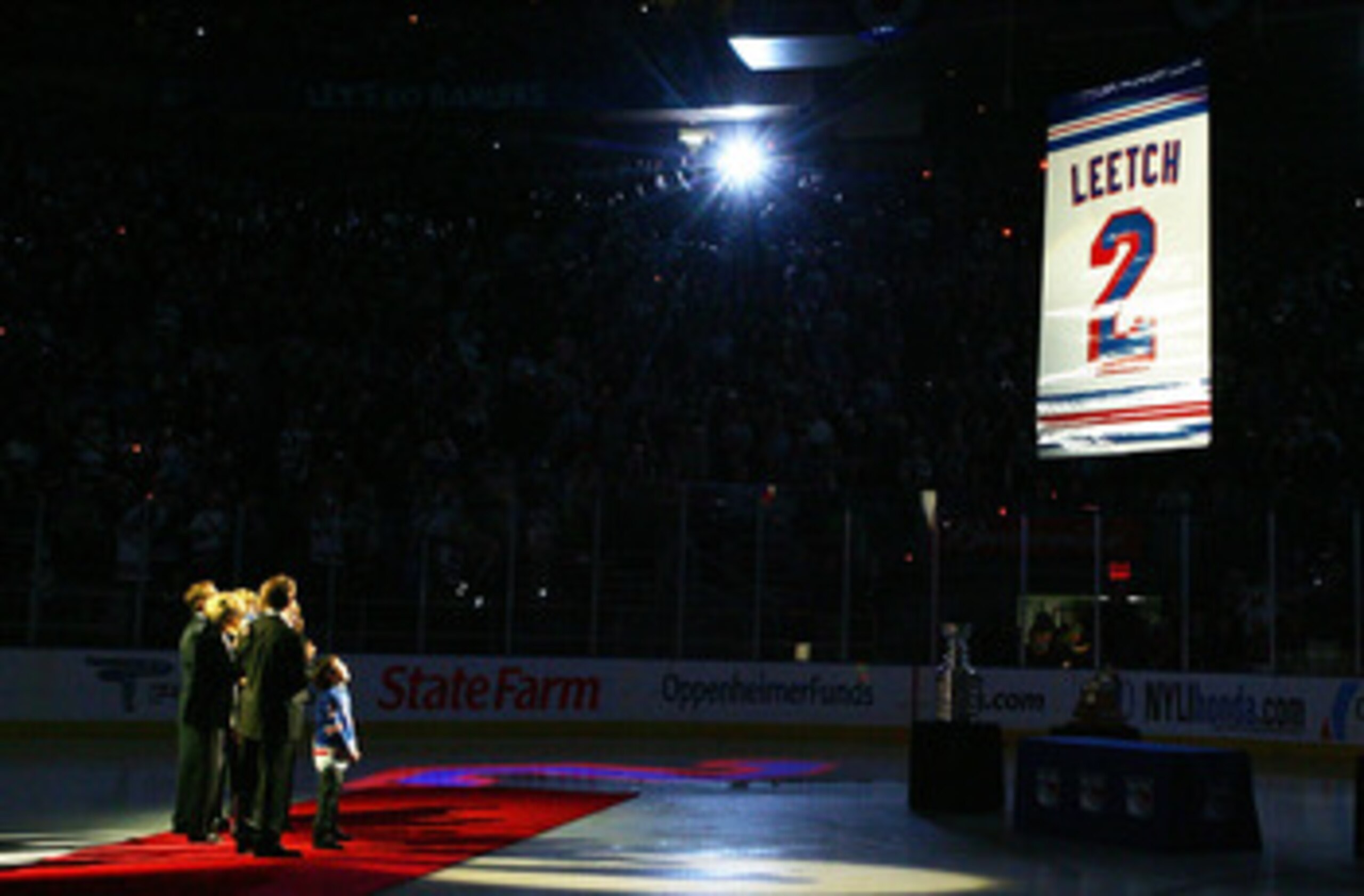 NEW YORK - JANUARY 24:  Former New York Ranger Brian Leetch stands with his family and friends as his banner is raised to the rafters before the game against the Atlanta Thrashers on January 24, 2008 at Madison Square Garden in New York City.Leetch became