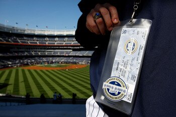 NEW YORK - APRIL 16:  A fan shows his game day ticket in the outfield stands during batting practice before the opening day game between the Cleveland Indians and the New York Yankees at the new Yankee Stadium on April 16, 2009 in the Bronx borough of New