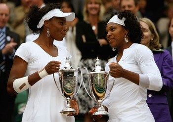 LONDON - JULY 05:  Venus Williams of United States and Serena Williams of United States celebrate with the trophy winning the women's doubles Final match against Lisa Raymond of United States and Samantha Stosur of Australia on day twelve of the Wimbledon