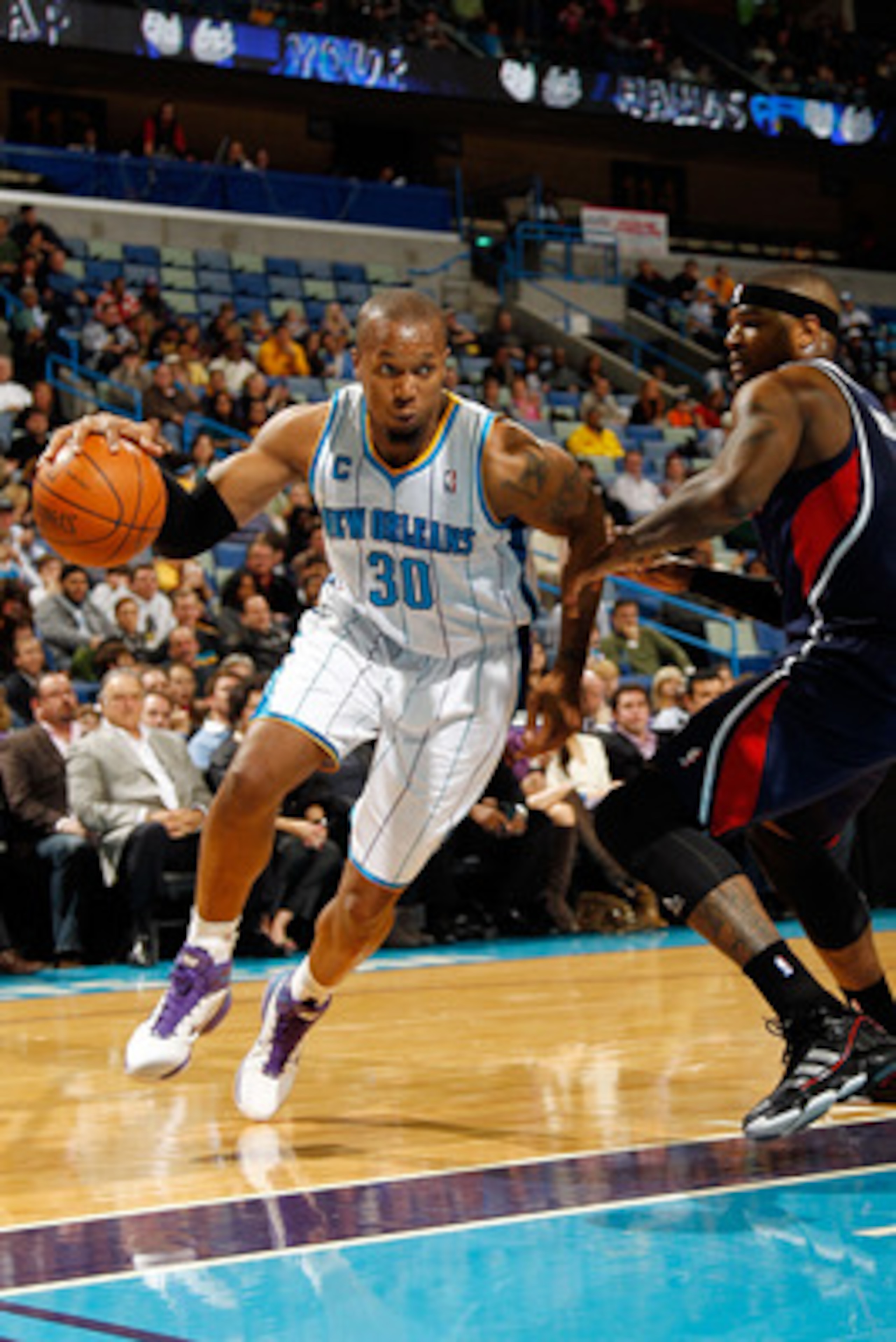 NEW ORLEANS, LA - DECEMBER 26: David West #30 of the New Orleans Hornets drives the ball around Josh Smith #5 of the Atlanta Hawks at the New Orleans Arena on December 26, 2010 in New Orleans, Louisiana. The Hornets defeated the Hawks 93-86. NOTE TO US NEW ORLEANS, LA - DECEMBER 26: David West #30 of the New Orleans Hornets drives the ball around Josh Smith #5 of the Atlanta Hawks at the New Orleans Arena on December 26, 2010 in New Orleans, Louisiana. The Hornets defeated the Hawks 93-86. NOTE TO US