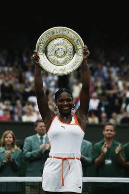 LONDON - JULY 5:  Serena Williams of the USA lifts the trophy up in the air after her victory over sister Venus Williams of the USA in the Womens Singles Final during day twelve of the Wimbledon Lawn Tennis Championships held on July 5, 2003 at the All En
