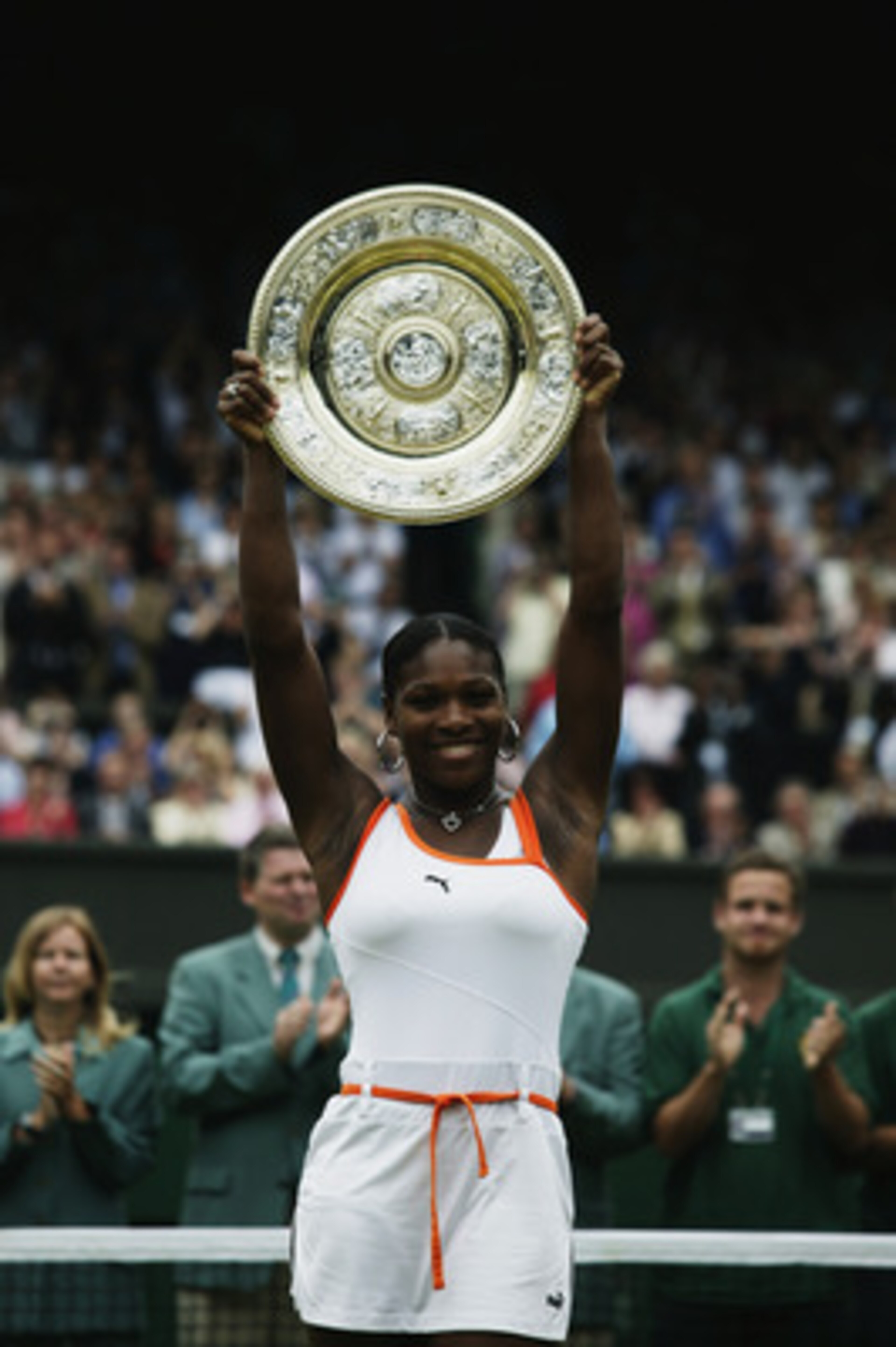 LONDON - JULY 5: Serena Williams of the USA lifts the trophy up in the air after her victory over sister Venus Williams of the USA in the Womens Singles Final during day twelve of the Wimbledon Lawn Tennis Championships held on July 5, 2003 at the All En LONDON - JULY 5: Serena Williams of the USA lifts the trophy up in the air after her victory over sister Venus Williams of the USA in the Womens Singles Final during day twelve of the Wimbledon Lawn Tennis Championships held on July 5, 2003 at the All En