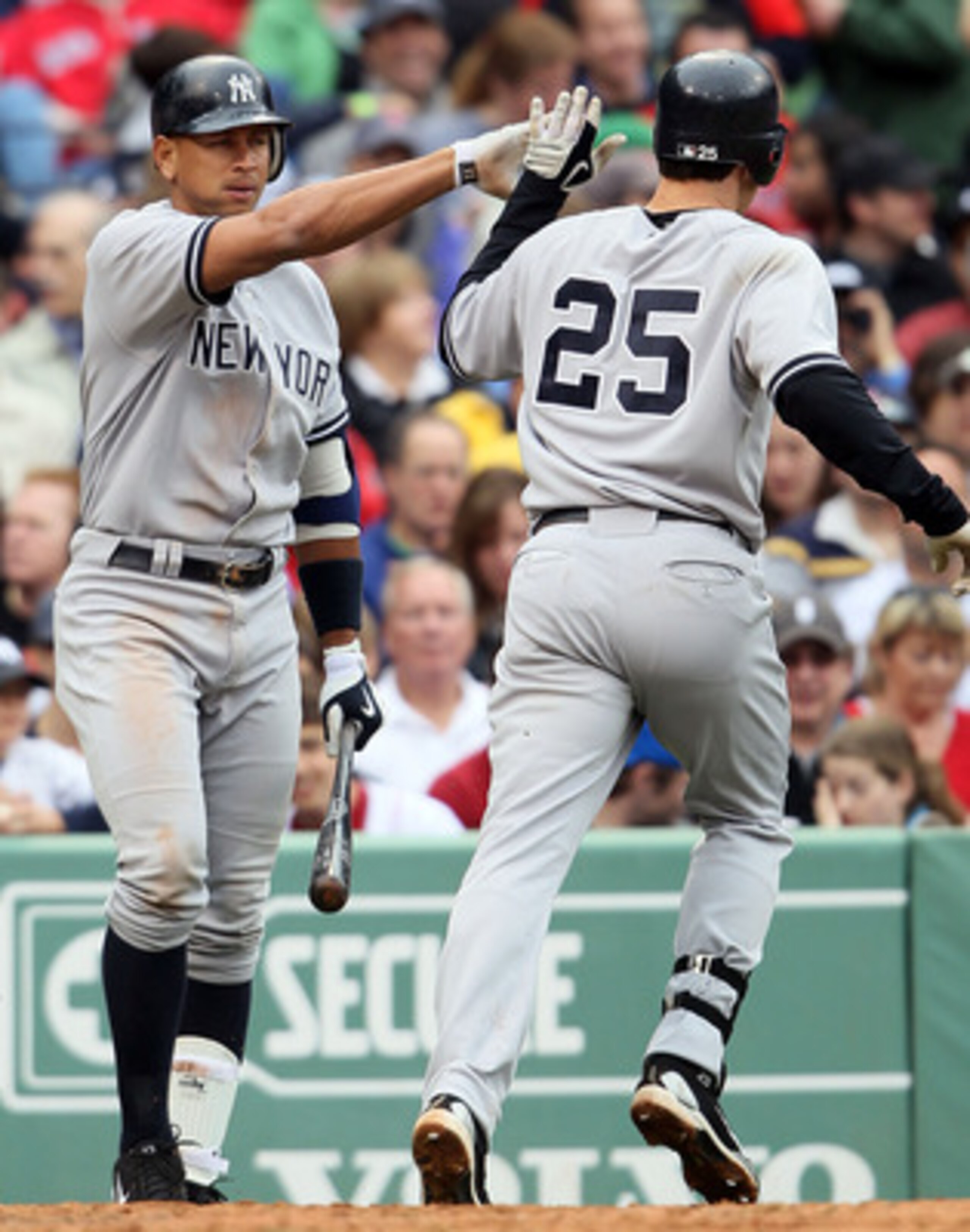 BOSTON - MAY 08:  Mark Teixeira #25 of the New York Yankees celebrates with teammate Alex Rodriguez #13 after Teixeira hit a solo home run in the fifth inning against the Boston Red Sox on May 8, 2010 at Fenway Park in Boston, Massachusetts.  (Photo by El