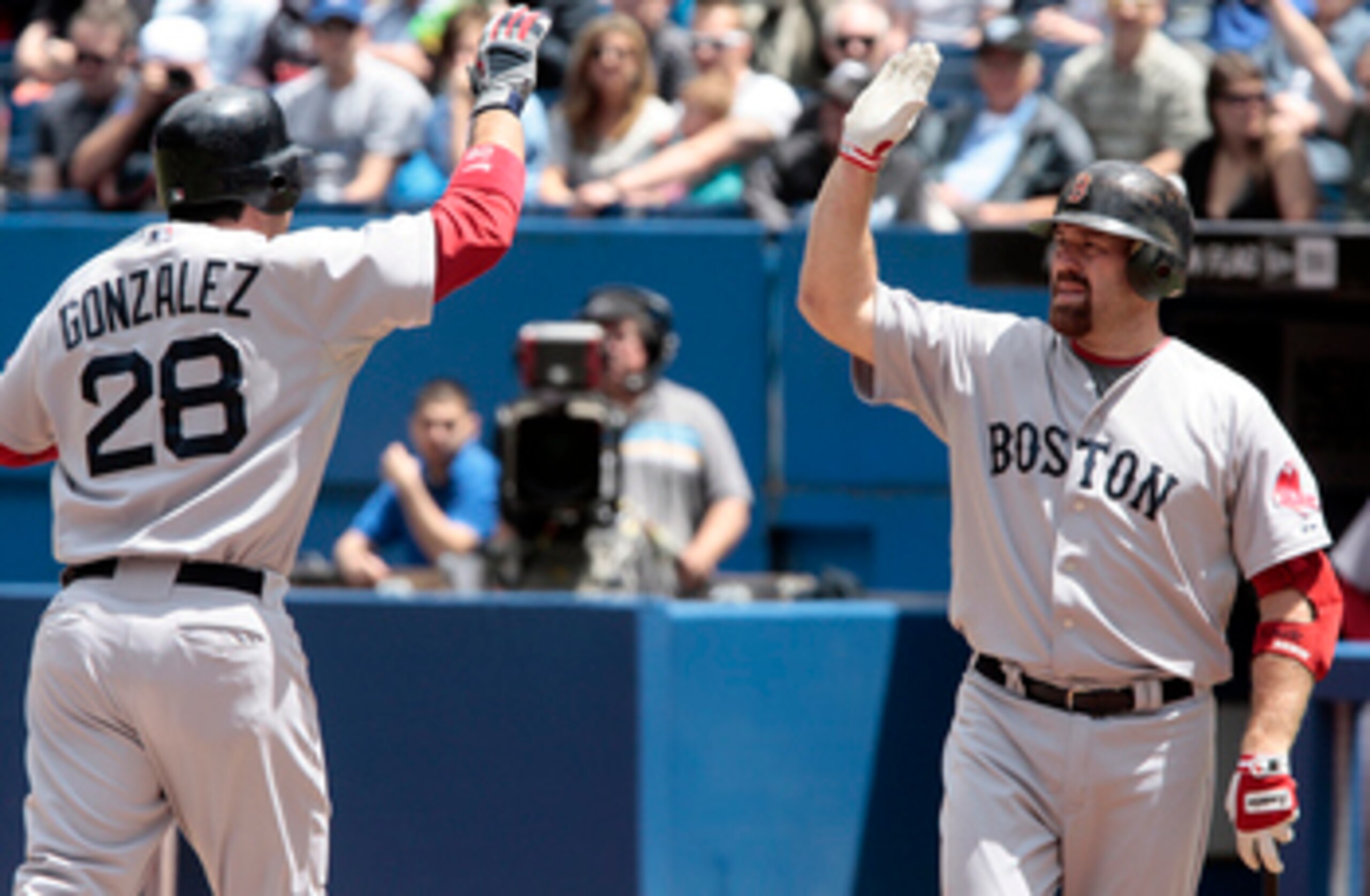 TORONTO, CANADA - JUNE 12:  Adrian Gonzalez #28 and Kevin Youkilis #20 of the Boston Red Sox celebrate a home run during MLB action against the Toronto Blue Jays at The Rogers Centre June 12, 2011 in Toronto, Ontario, Canada. (Photo by Abelimages/Getty Im