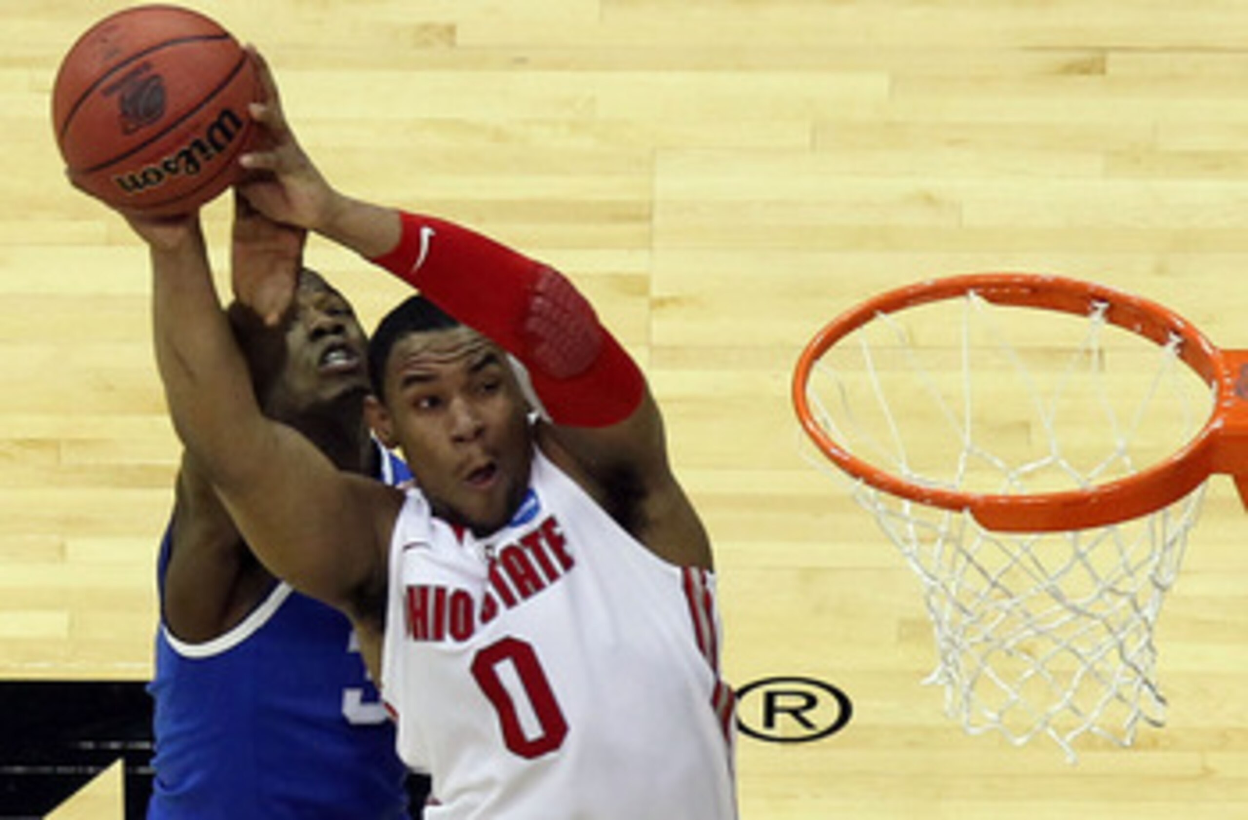 NEWARK, NJ - MARCH 25:  Jared Sullinger #0 of the Ohio State Buckeyes goes for a lay up against DeAndre Liggins #34 of the Kentucky Wildcats during the second half of the east regional semifinal of the 2011 NCAA Men's Basketball Tournament at the Prudenti