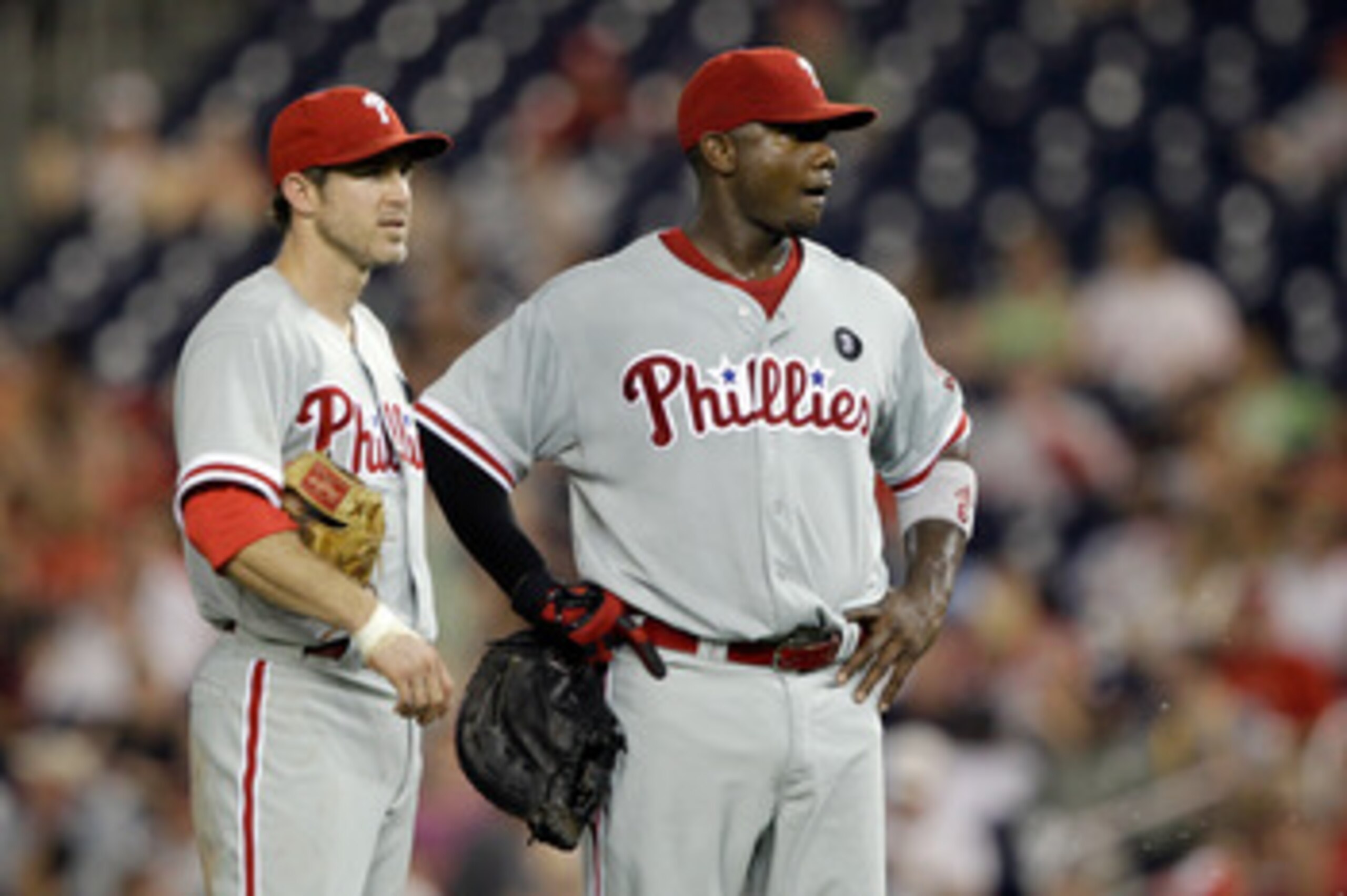 WASHINGTON, DC - MAY 31: Chase Utley #26 of the Philadelphia Phillies and Ryan Howard #6 talk between innings against the Washington Nationals  at Nationals Park on May 31, 2011 in Washington, DC. The Braves won 2-0. (Photo by Rob Carr/Getty Images)