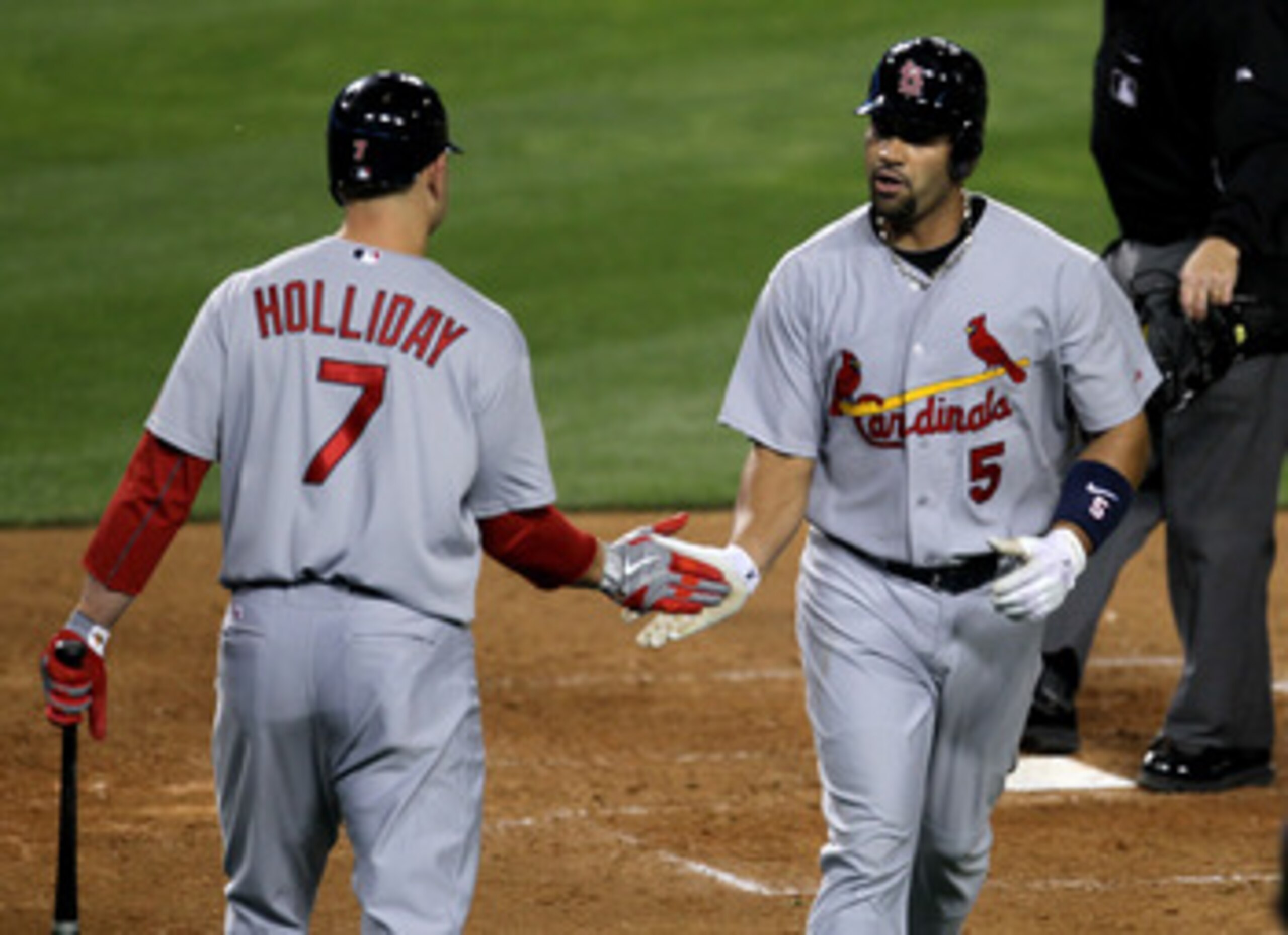 LOS ANGELES, CA - APRIL 14:  Albert Pujols #5 of the St Louis Cardinals is greeted by Matt Holliday #7 as he scores on his home run in the fifth inning against the Los Angeles Dodgers on April 14, 2011 at Dodger Stadium in Los Angeles, California.  (Photo