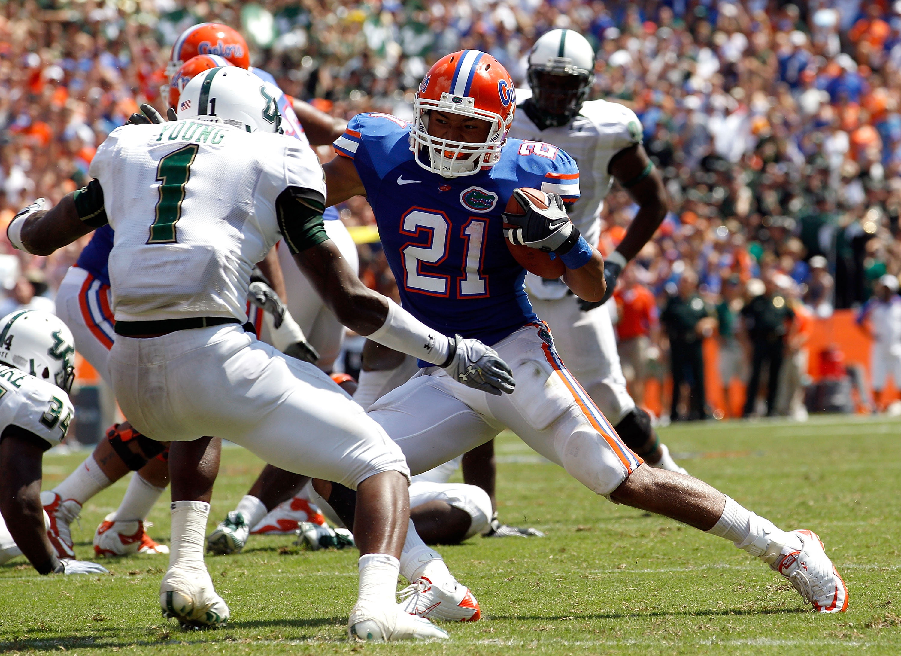 GAINESVILLE, FL - SEPTEMBER 11:  Emmanuel Moody #21 of the Flokrida Gators attempts to run past Jerrell Young #1 of the South Florida Bulls during a game at Ben Hill Griffin Stadium on September 11, 2010 in Gainesville, Florida.  (Photo by Sam Greenwood/G