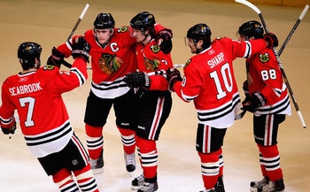CHICAGO, IL - APRIL 17: (L-R) Brent Seabrook #7, Jonathan Toews #19, Duncan Keith #2, Patrick Sharp #10 and Patrick Kane #88 of the Chicago Blackhawks celebrate Keith's 1st period power-play goal against the Vancouver Canucks in Game Three of the Western 