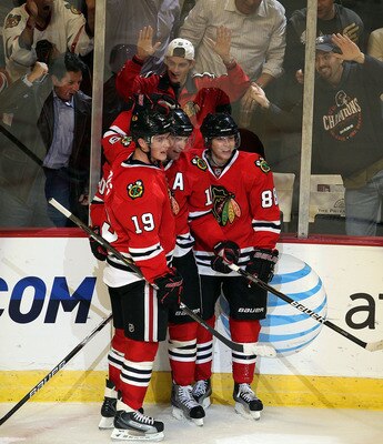 CHICAGO - OCTOBER 27: (L-R) Jonathan Toews #19, Patrick Sharp #10 and Patrick Kane #88 of the Chicago Blackhawks celebrate a 3rd period goal by Sharp against the Los Angeles Kings at the United Center on October 27, 2010 in Chicago, Illinois. The Blackhaw