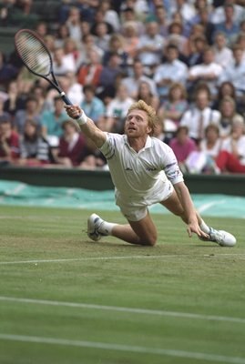 1990:  Boris Becker of Germany slips as he reaches for a ball during the Lawn Tennis Championships at Wimbledon in London. \ Mandatory Credit: Mike  Hewitt/Allsport