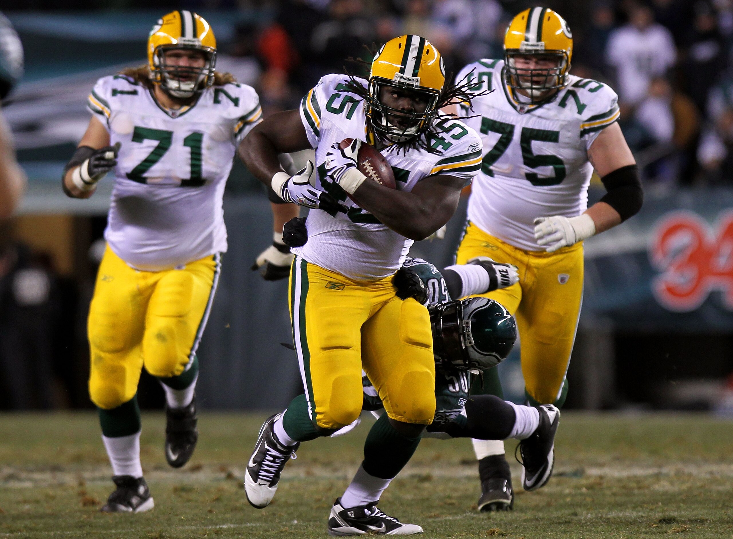 PHILADELPHIA, PA - JANUARY 09:  Quinn Johnson #45 of the Green Bay Packers tries to avoid the tackle of Ernie Sims #50 of the Philadelphia Eagles during the 2011 NFC wild card playoff game at Lincoln Financial Field on January 9, 2011 in Philadelphia, Pen
