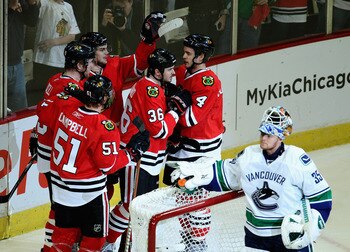 CHICAGO, IL - APRIL 24: (L-R) Brian Campbell #51, Bryan Bickell #29, Michael Frolik #67, Dave Bolland #36 and Niklas Hjalmarsson #4 of the Chicago Blackhawks celebrate a 1st period goal against Cory Schneider #35 of the Vancouver Canucks in Game Six of th