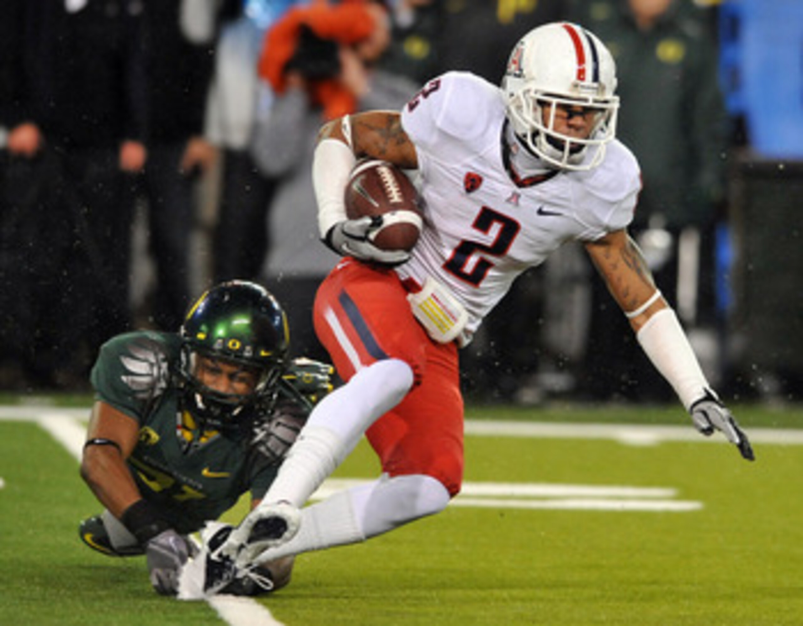 EUGENE, OR - NOVEMBER 26: Cornerback Avery Patterson #31 of the Oregon Ducks tackles cornerback Mike Turner #2 of the Arizona Wildcatsin the fourth quarter of the game at Autzen Stadium on November 26, 2010 in Eugene, Oregon. The Ducks won the game 48-29.