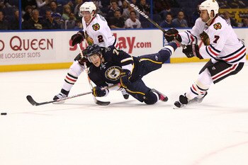 ST. LOUIS - OCTOBER 22: T.J. Oshie #74 of the St. Louis Blues is tripped up by Duncan Keith #2 and Brent Seabrook #7 both of the Chicago Blackhawks at the Scottrade Center on October 22, 2010 in St. Louis, Missouri.  (Photo by Dilip Vishwanat/Getty Images