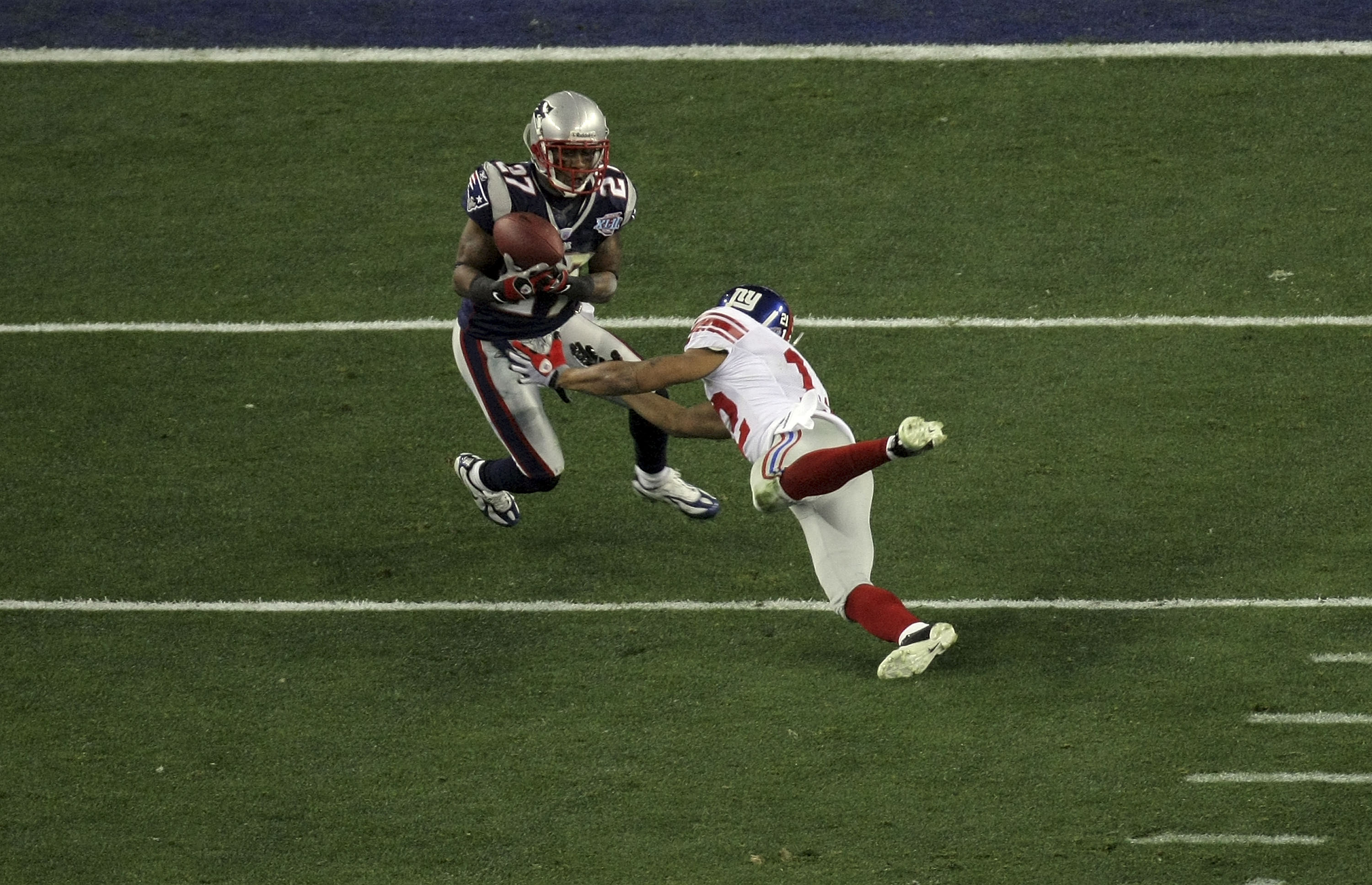 GLENDALE, AZ - FEBRUARY 03:  Ellis Hobbs III #27 of the New England Patriots intercepts a pass in the second quarter against Steve Smith #12 of the New York Giants during Super Bowl XLII on February 3, 2008 at the University of Phoenix Stadium in Glendale
