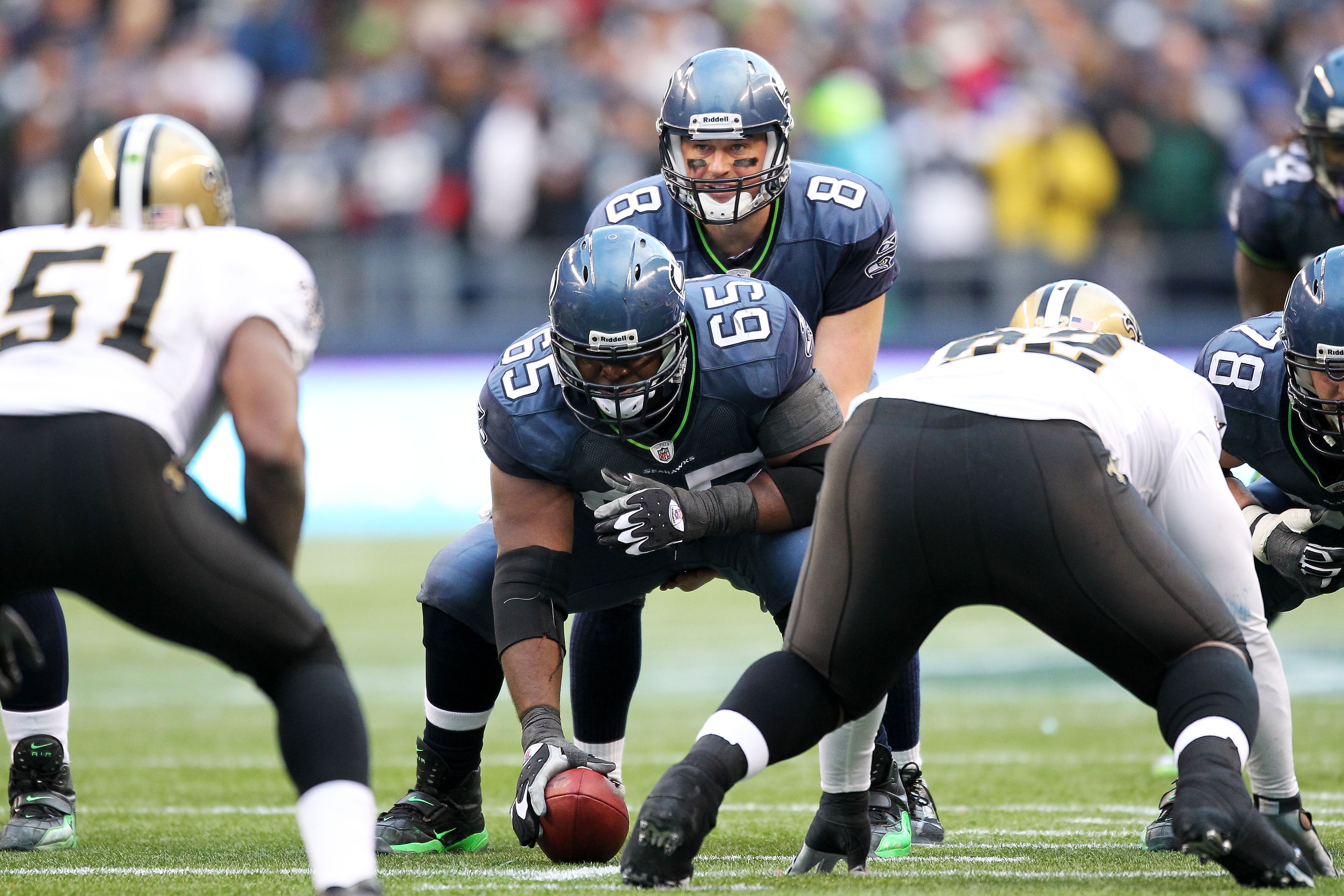 SEATTLE, WA - JANUARY 08:  Center Chris Spencer #65 prepares to snap the football to Matt Hasselbeck #8 of the Seattle Seahawks against the New Orleans Saints during the 2011 NFC wild-card playoff game at Qwest Field on January 8, 2011 in Seattle, Washing