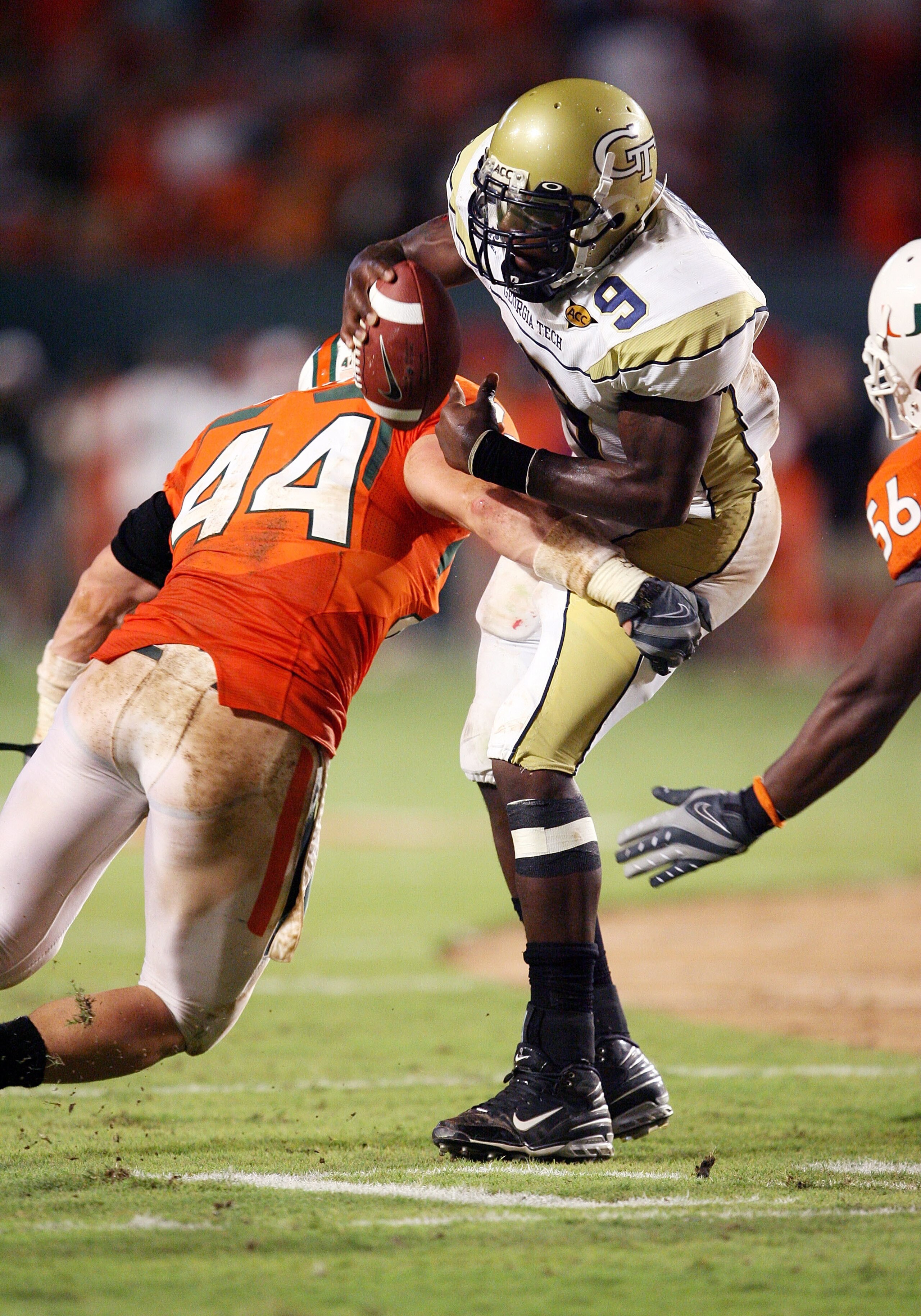 FORT LAUDERDALE, FL - SEPTEMBER 17: Quarterback Josh Nesbitt #9 of the Georgia Tech Yellow Jackets is brought down by linebacker Colin McCarthy #44 of the Miami Hurricanes at Land Shark Stadium on September 17, 2009 in Fort Lauderdale, Florida. Miami def FORT LAUDERDALE, FL - SEPTEMBER 17: Quarterback Josh Nesbitt #9 of the Georgia Tech Yellow Jackets is brought down by linebacker Colin McCarthy #44 of the Miami Hurricanes at Land Shark Stadium on September 17, 2009 in Fort Lauderdale, Florida. Miami def