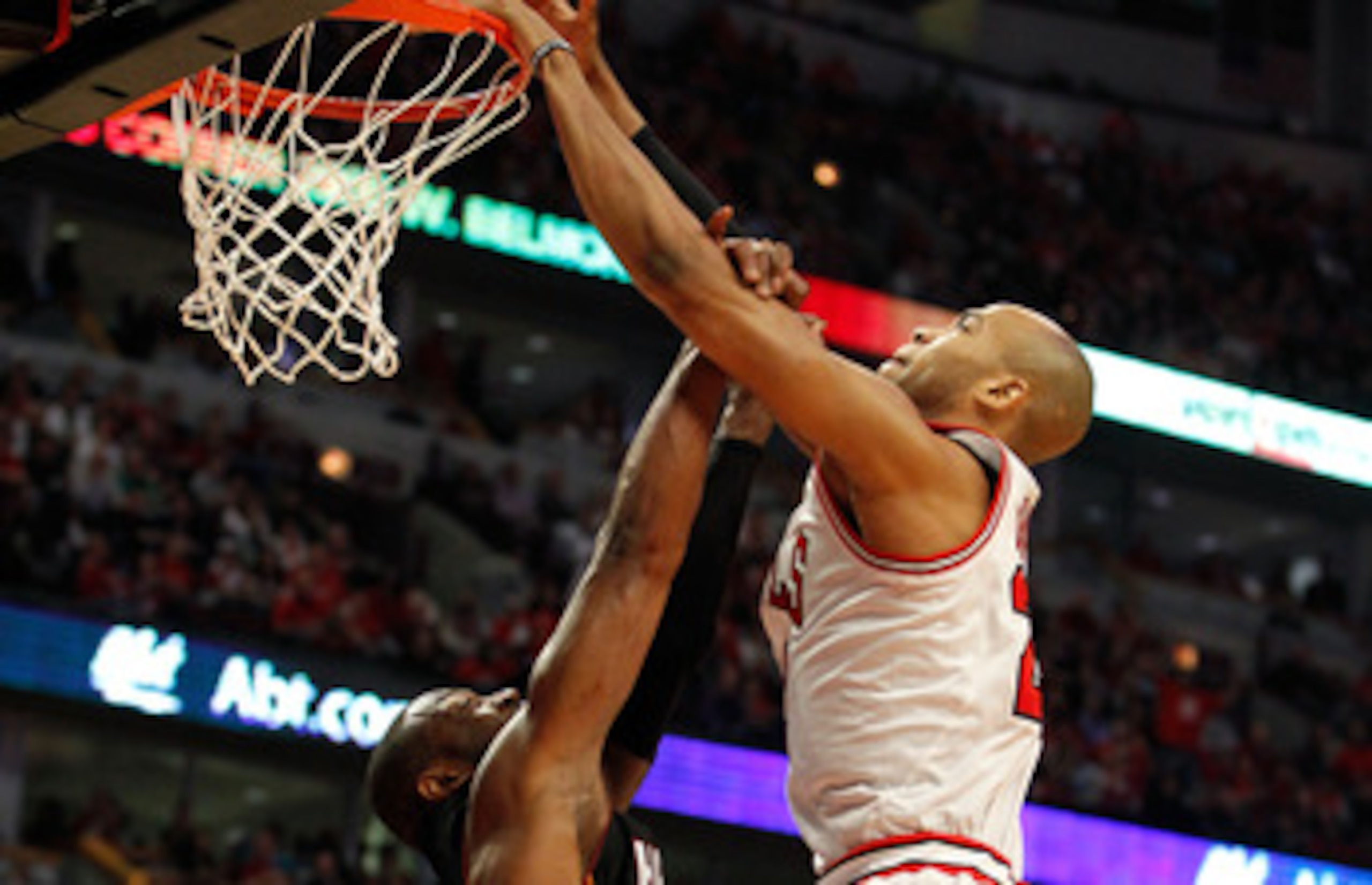 CHICAGO, IL - MAY 15:  Taj Gibson #22 of the Chicago Bulls dunks against Dwyane Wade #3 of the Miami Heat in Game One of the Eastern Conference Finals during the 2011 NBA Playoffs on May 15, 2011 at the United Center in Chicago, Illinois. NOTE TO USER: Us