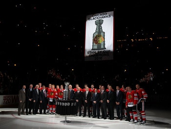 CHICAGO - OCTOBER 09: Members of the Chicago Blackhawks and their staff pose for a photo as the Stanley Cup Championship banner is raised during a ceremony before the Blackhawks season home opening game against the Detroit Red Wings at the United Center o